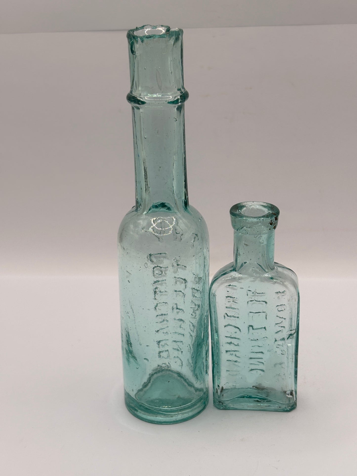 Old aqua glass advertising bottles. Pritchard teething powders