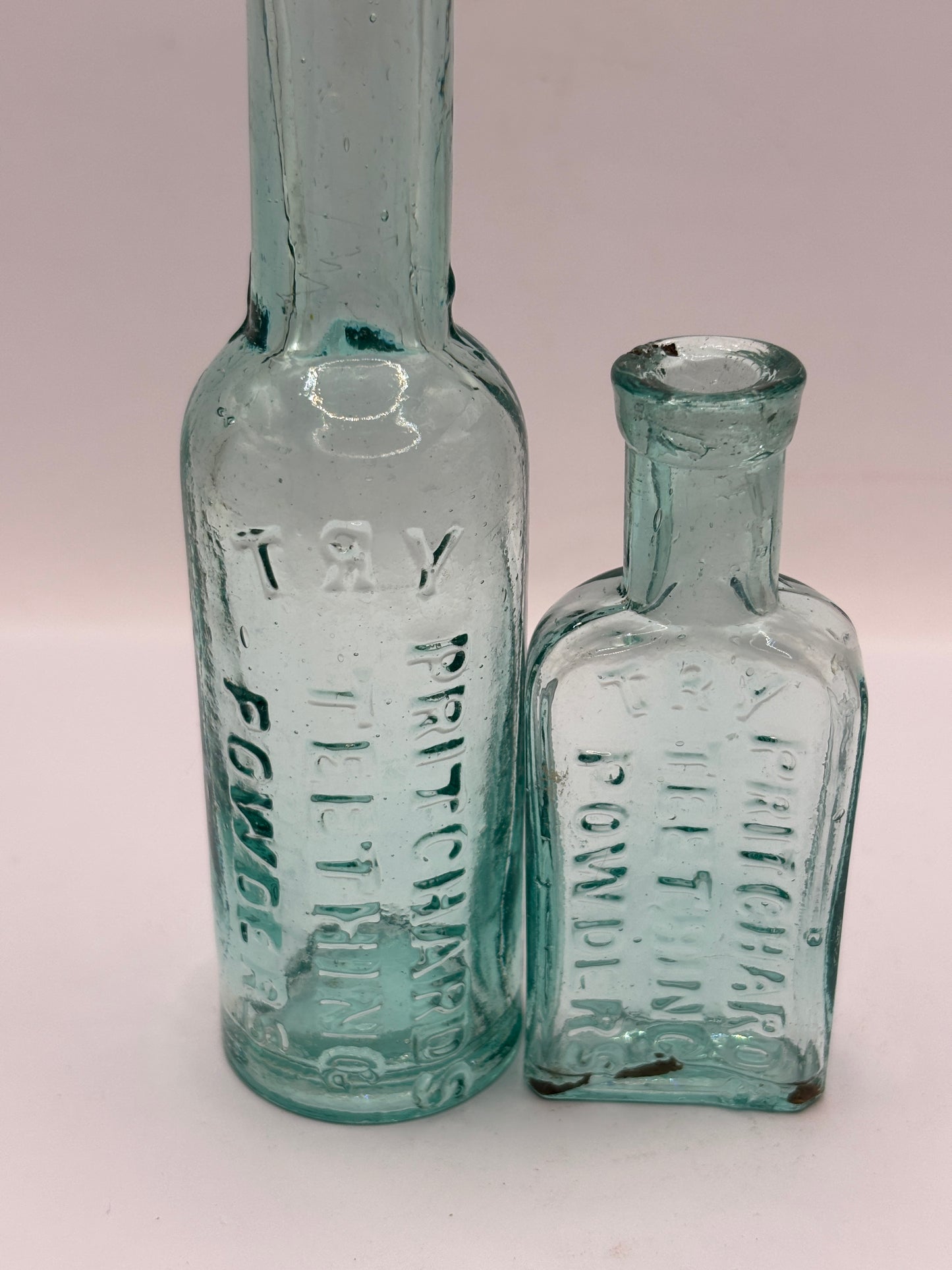 Old aqua glass advertising bottles. Pritchard teething powders