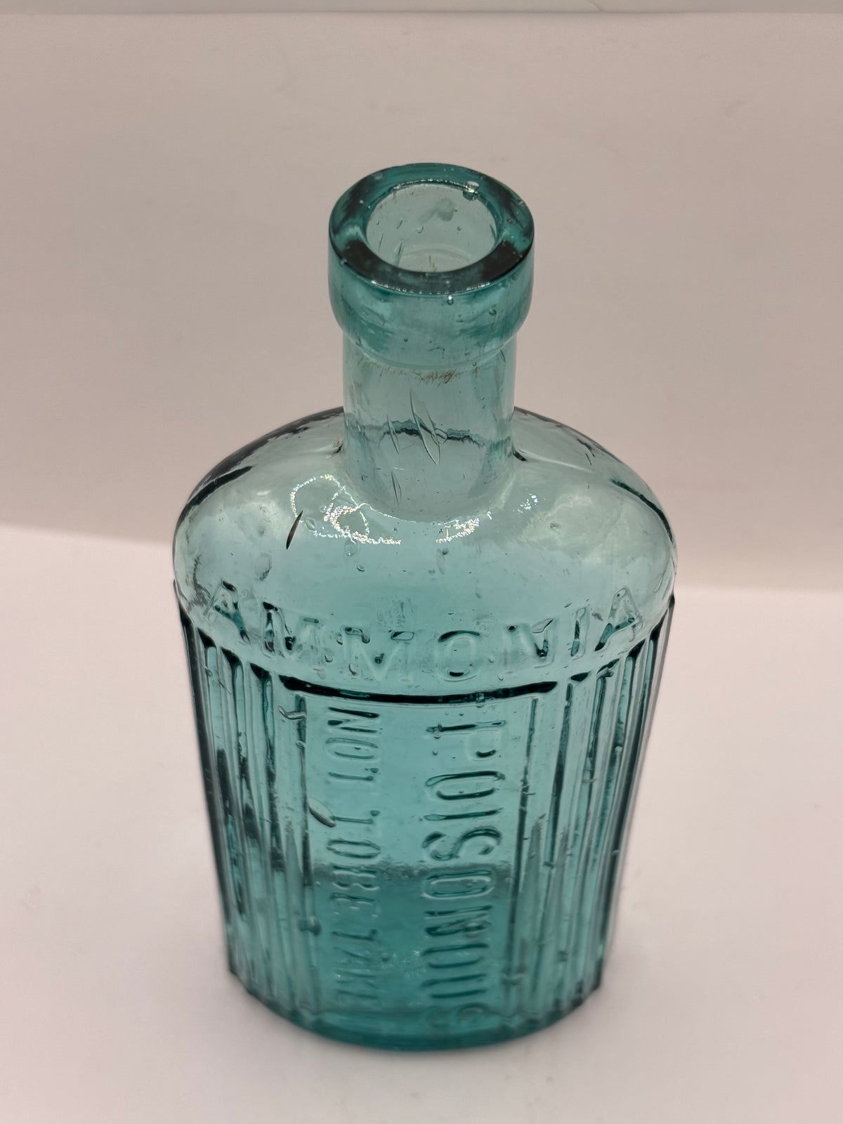 Old aqua glass poison bottle, ammonia, POISONOUS not to be taken