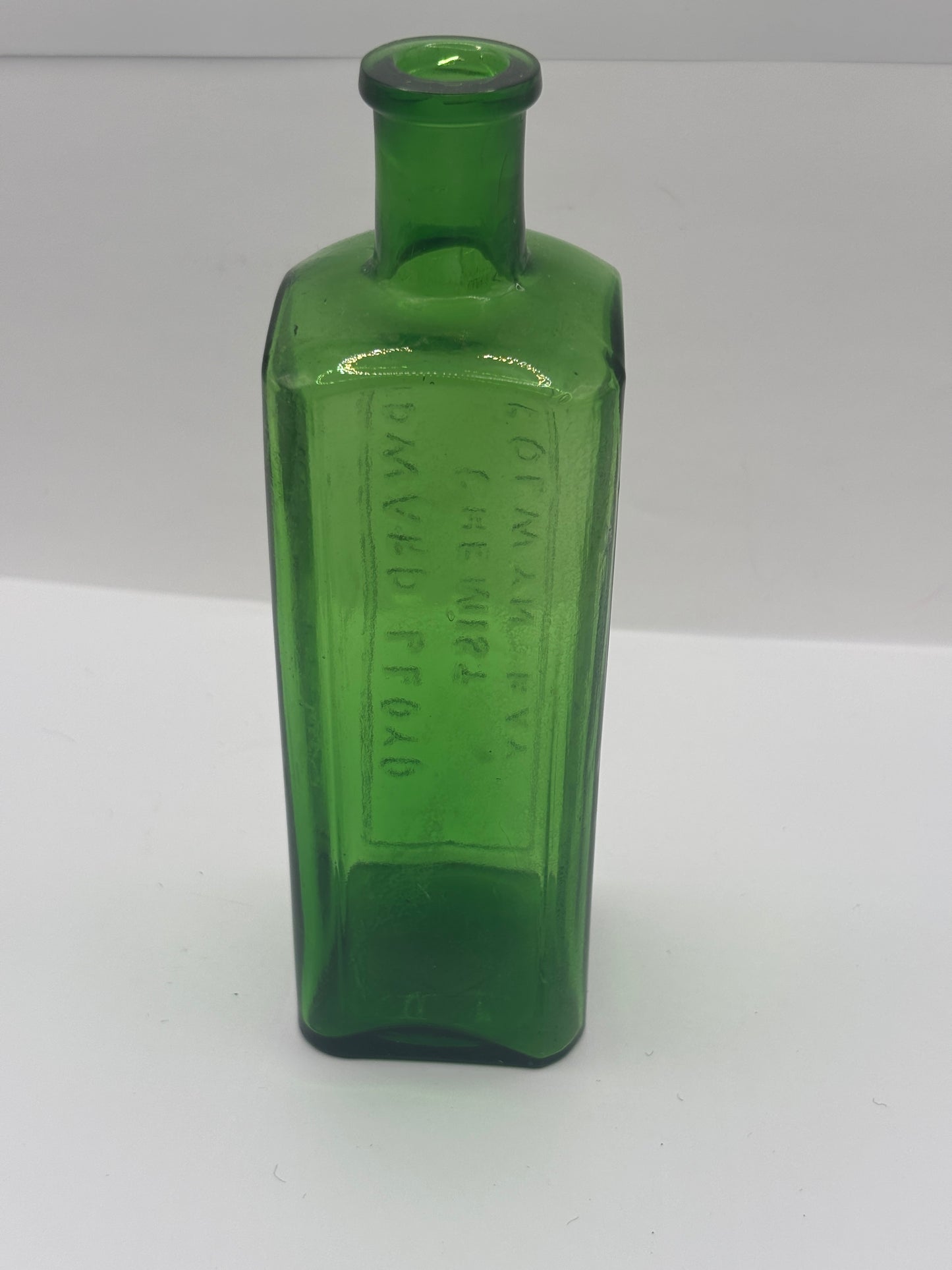 Old green glass advertising chemist bottle. Edward Lloyd chemist Colwyn bay