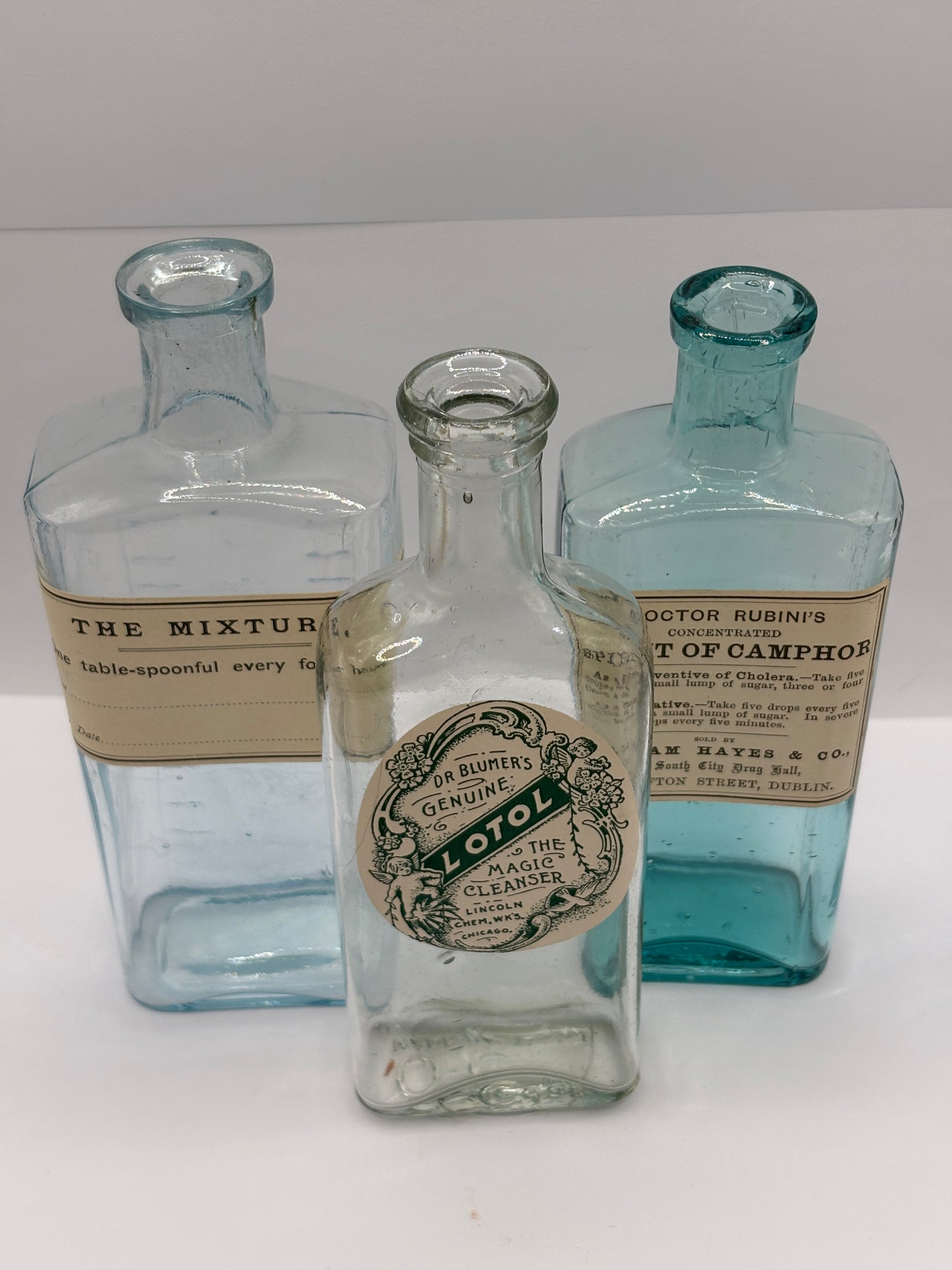 3 old chemist bottles with added labels