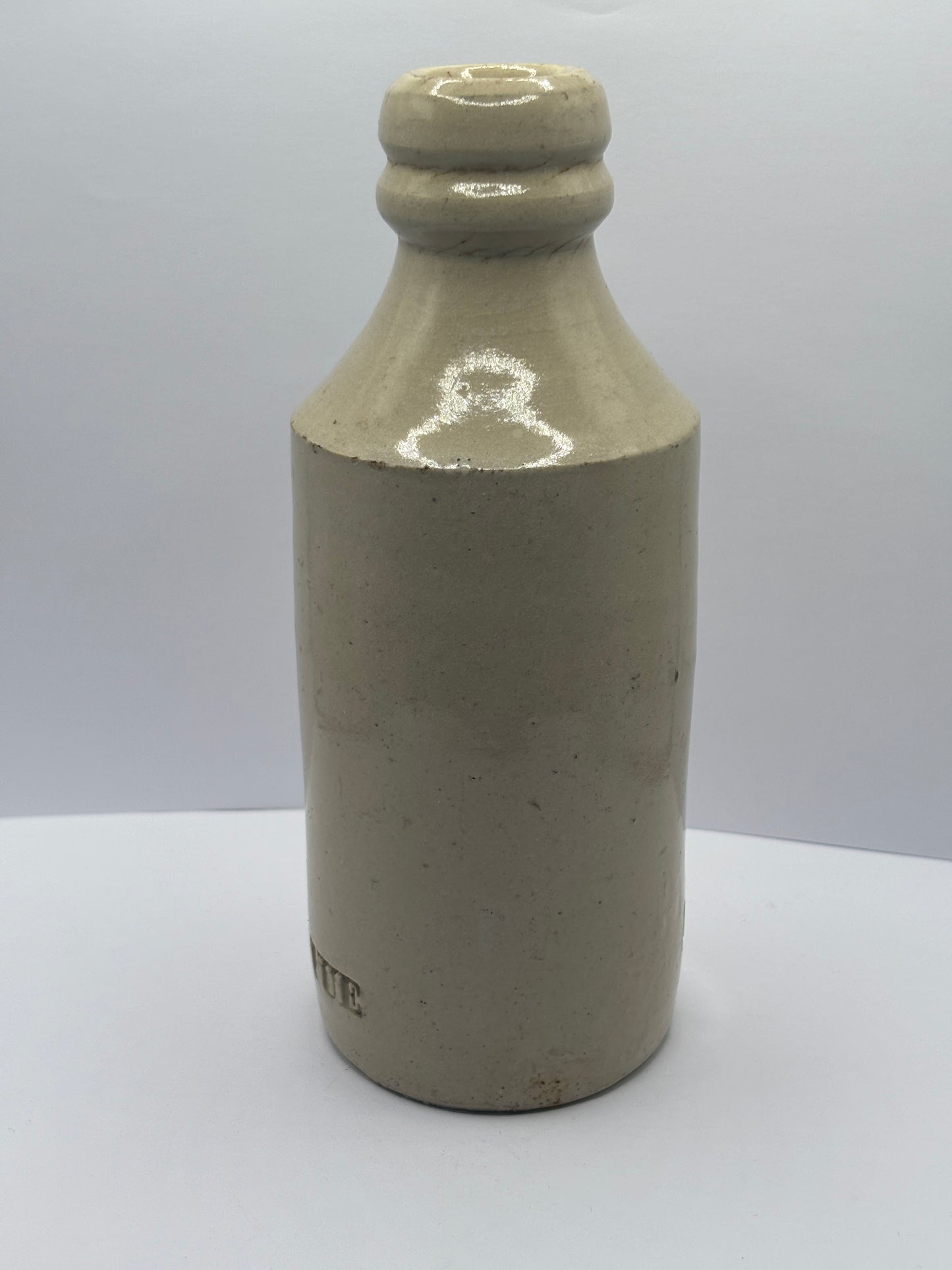 Old white stoneware Belle vue ginger beer bottle