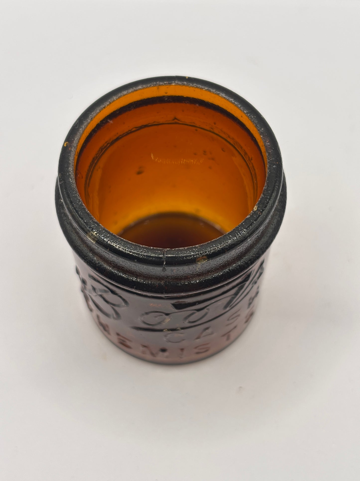 Small old amber glass boots jar