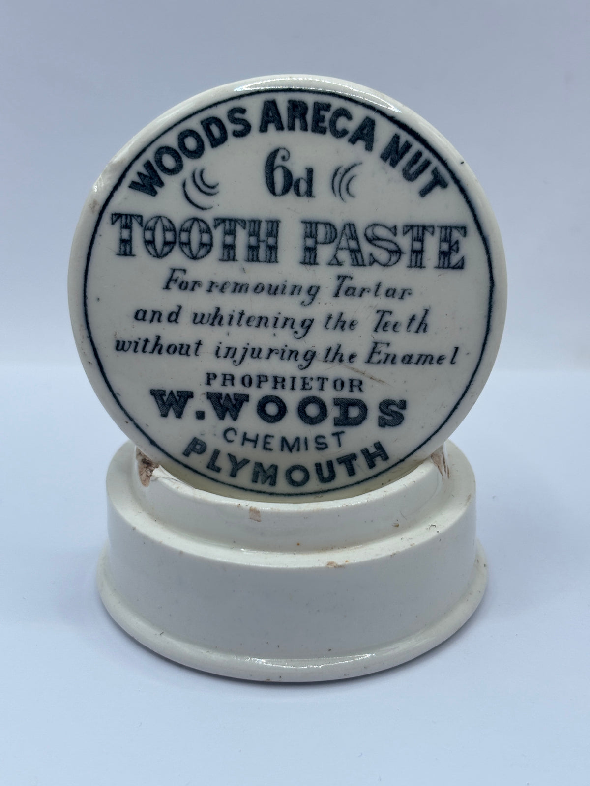 Old advertising lid and base. Woods areca nut tooth paste. Damaged