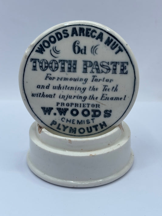 Old advertising lid and base. Woods areca nut tooth paste. Damaged