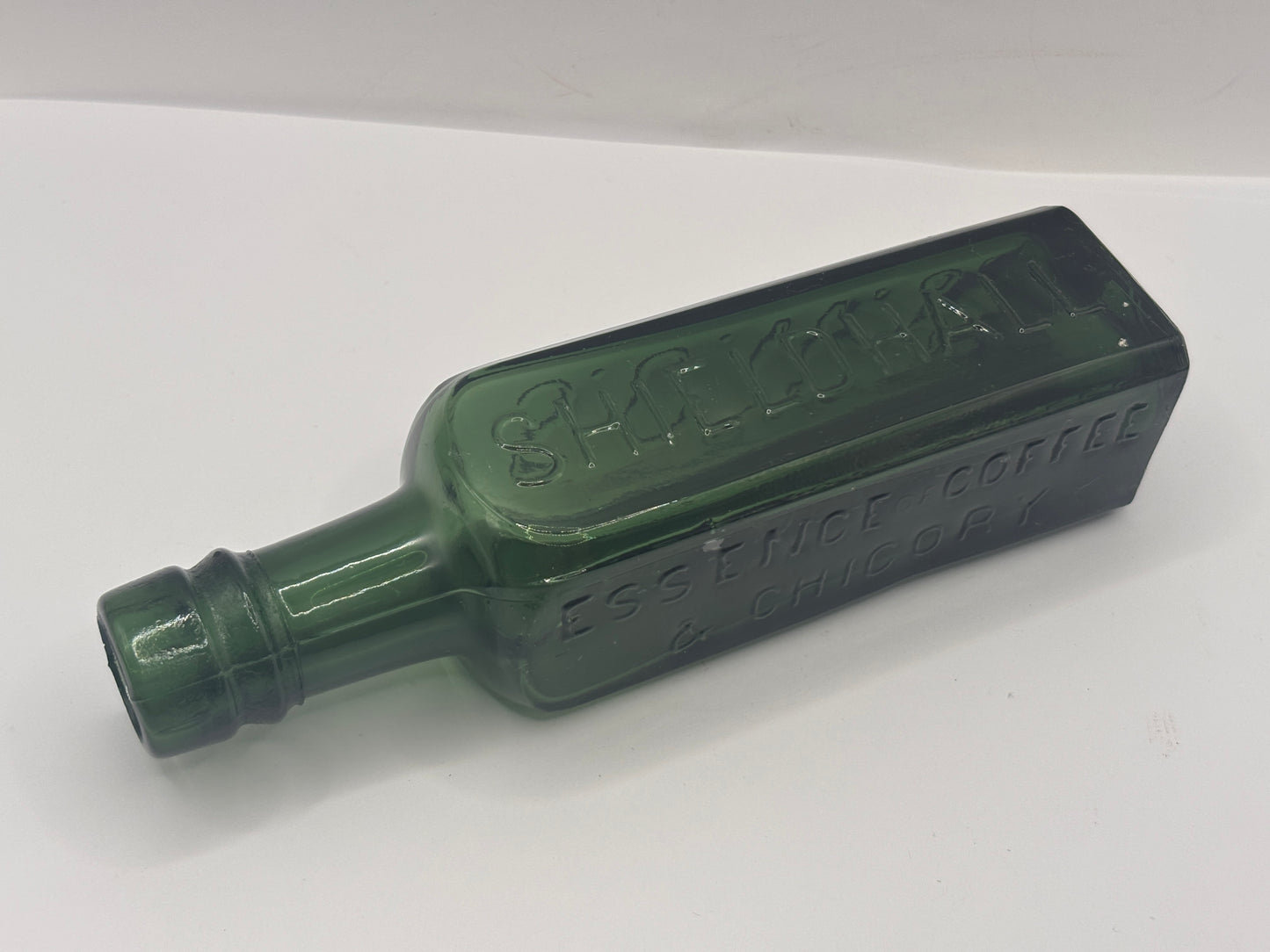 Old green glass essence of coffee & chicory bottle