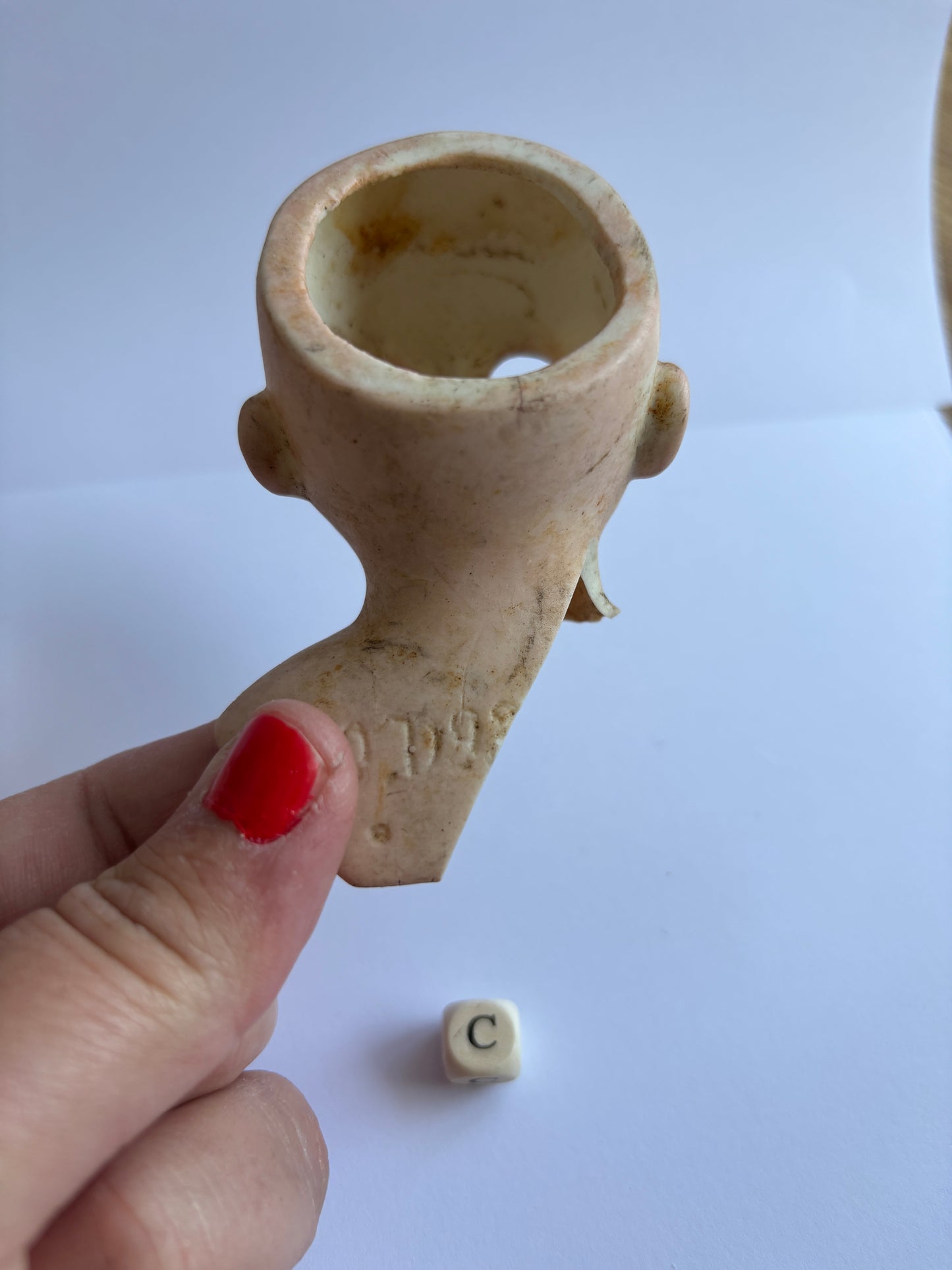 crusty old dolls head, damaged (c)