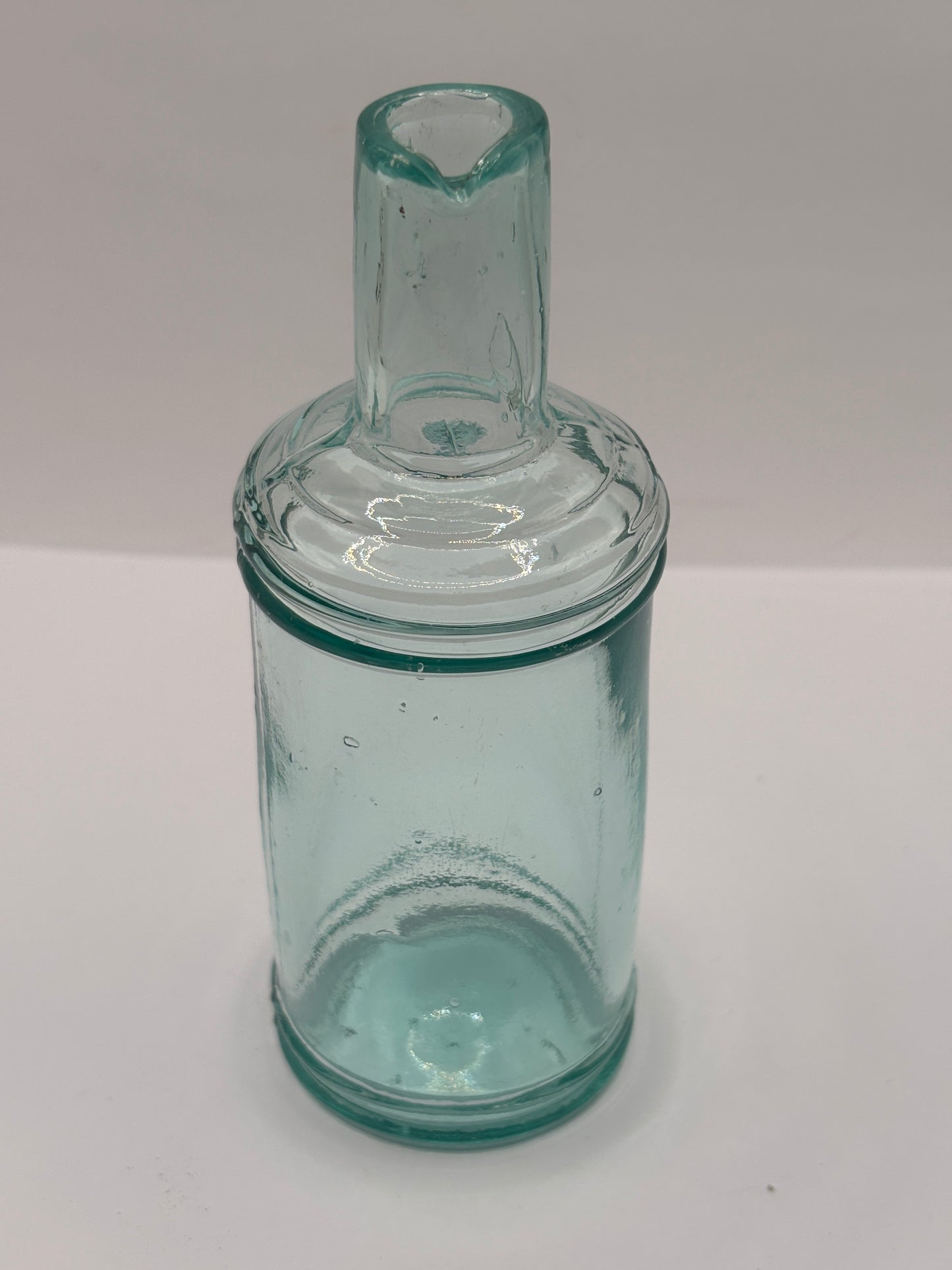 Old tall aqua glass pouring ink, inkwell