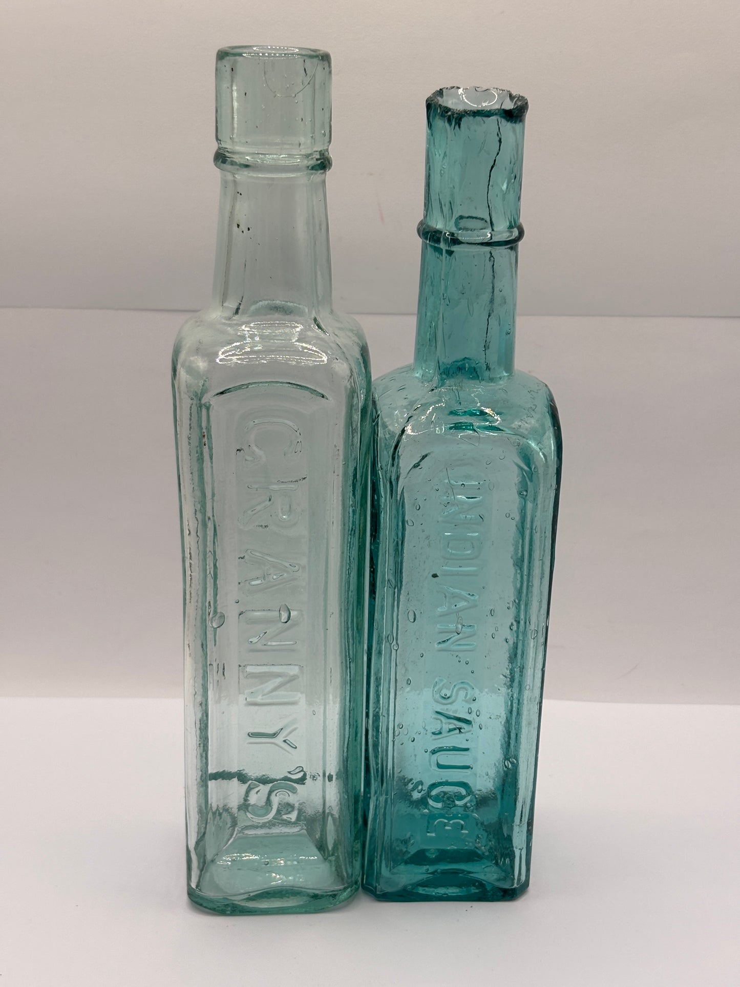 2 old aqua glass sauce bottles, Grannys & indian sauce