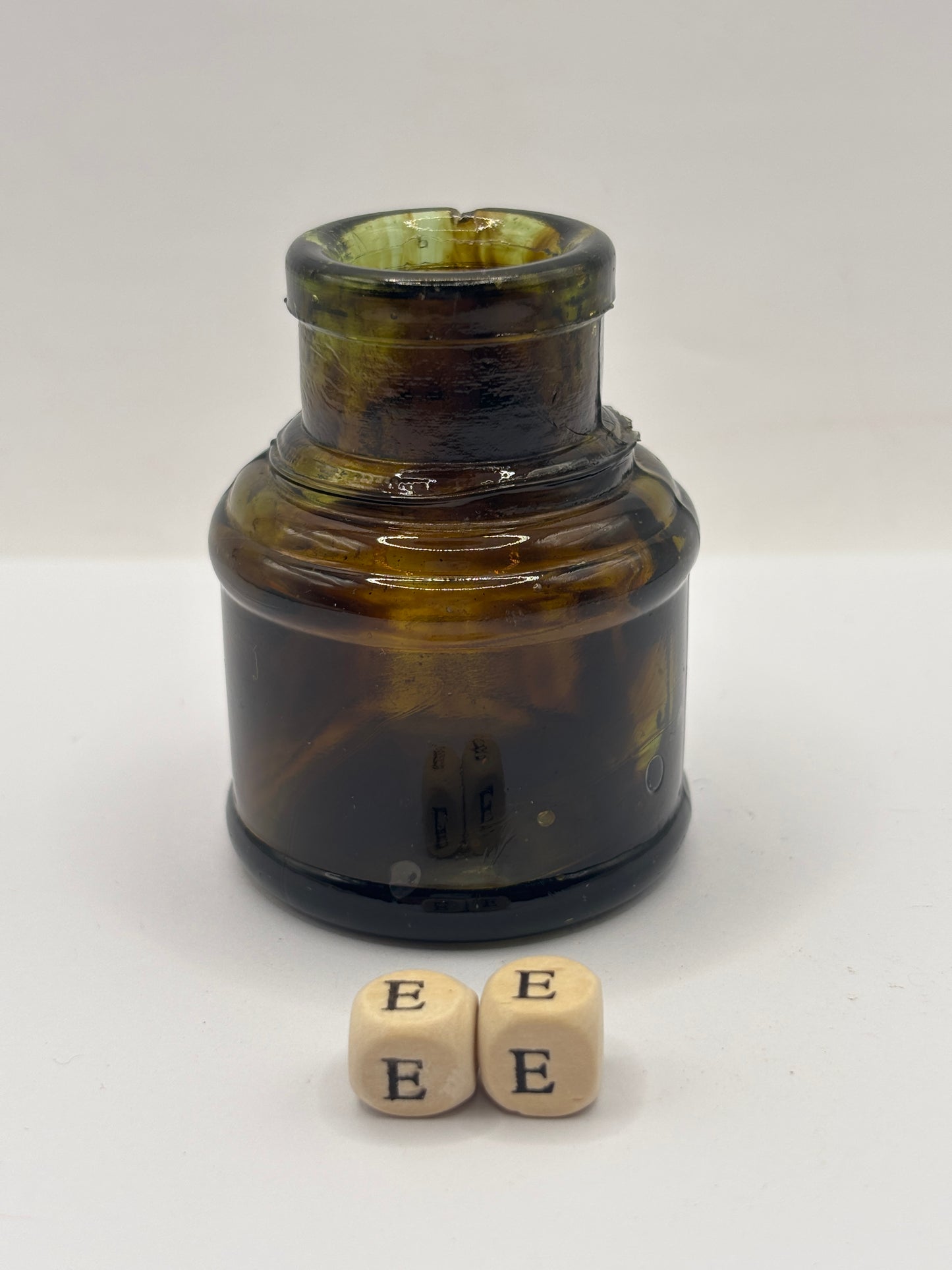 Old dark amber inkwell, ink bottle. Swirly (ee)