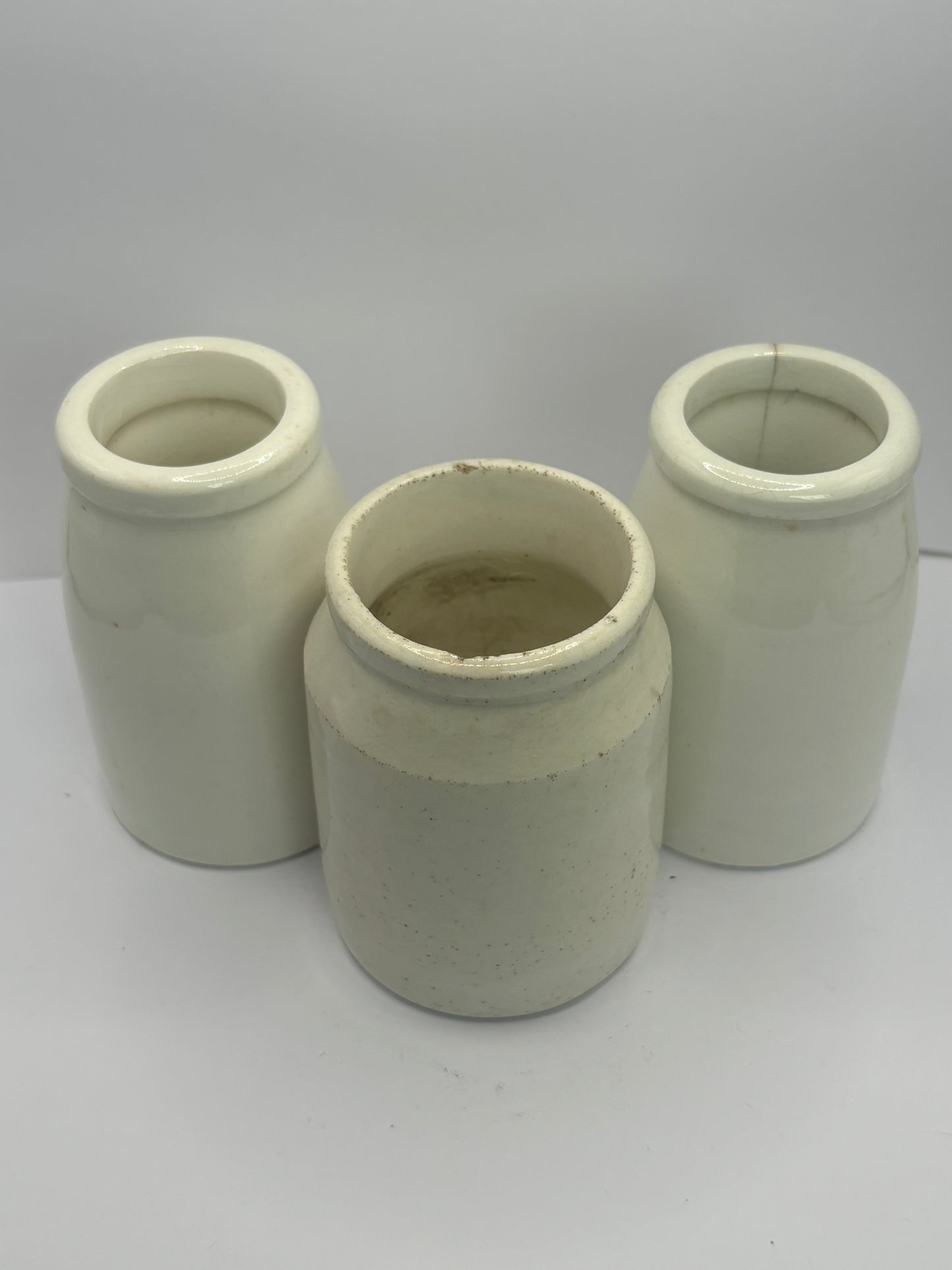 3 small white stoneware pots