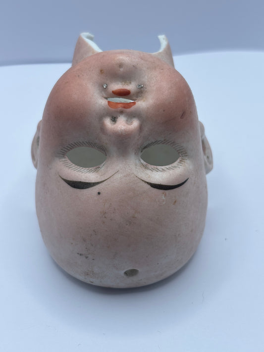 Old dolls head, damaged
