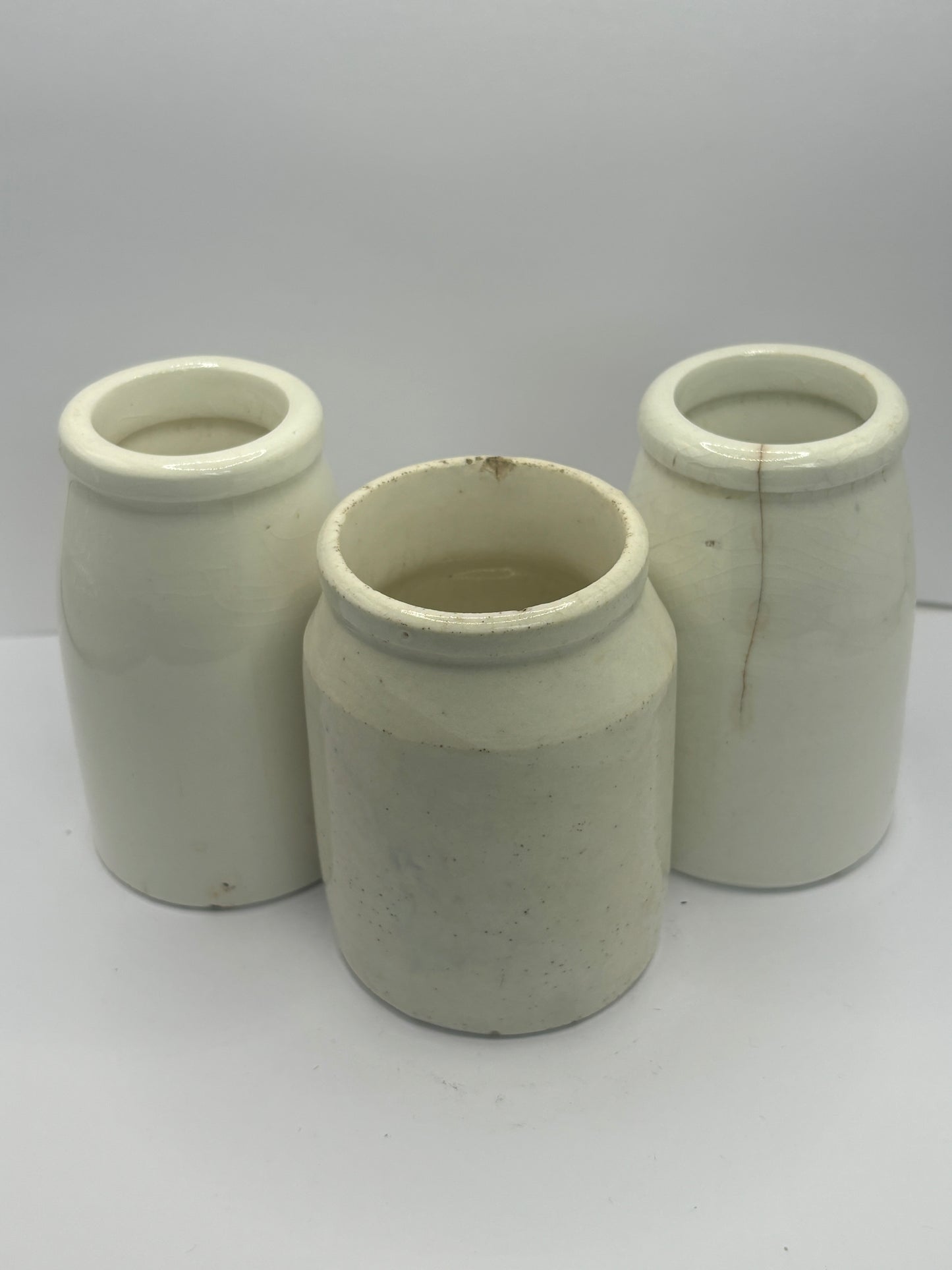 3 small white stoneware pots