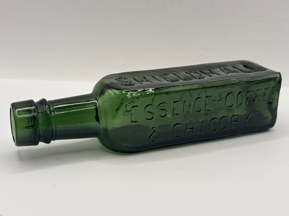 Old green glass essence of coffee bottle