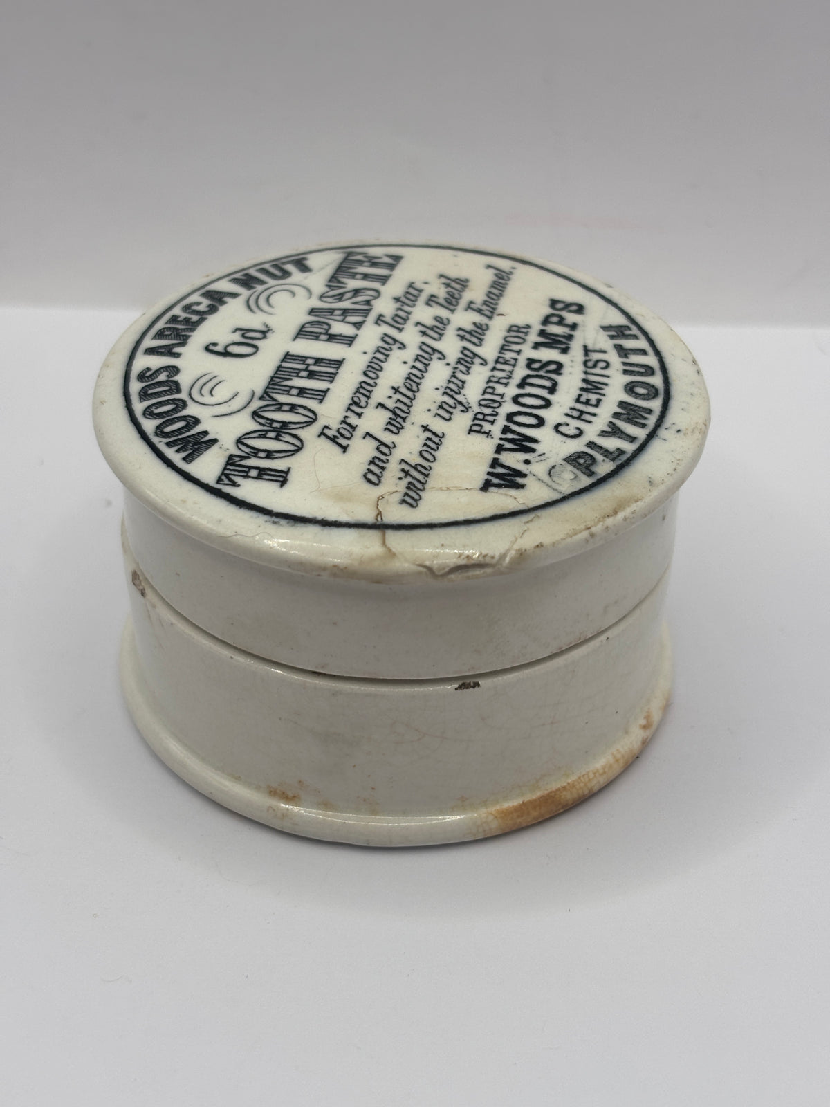 Old advertising lid and base. Woods areca nut tooth paste. Damaged