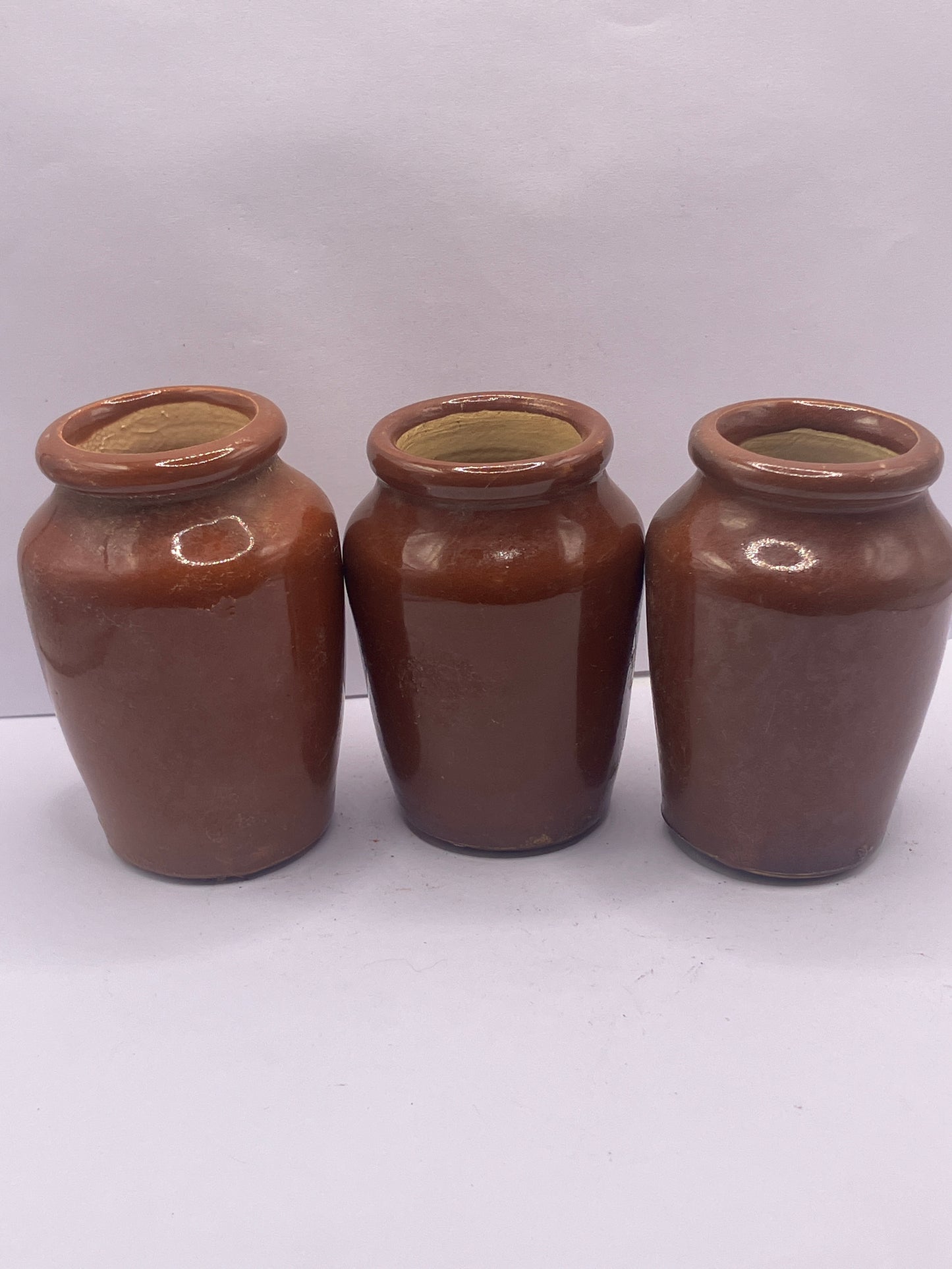 3 small brown stoneware cream pots