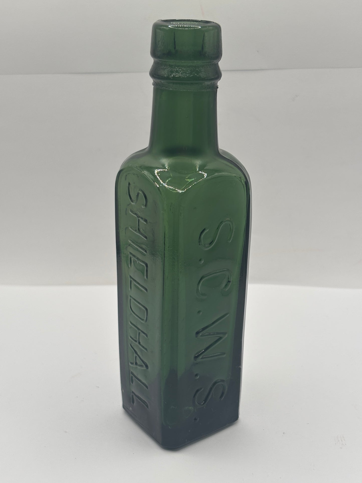 Old green glass essence of coffee & chicory bottle