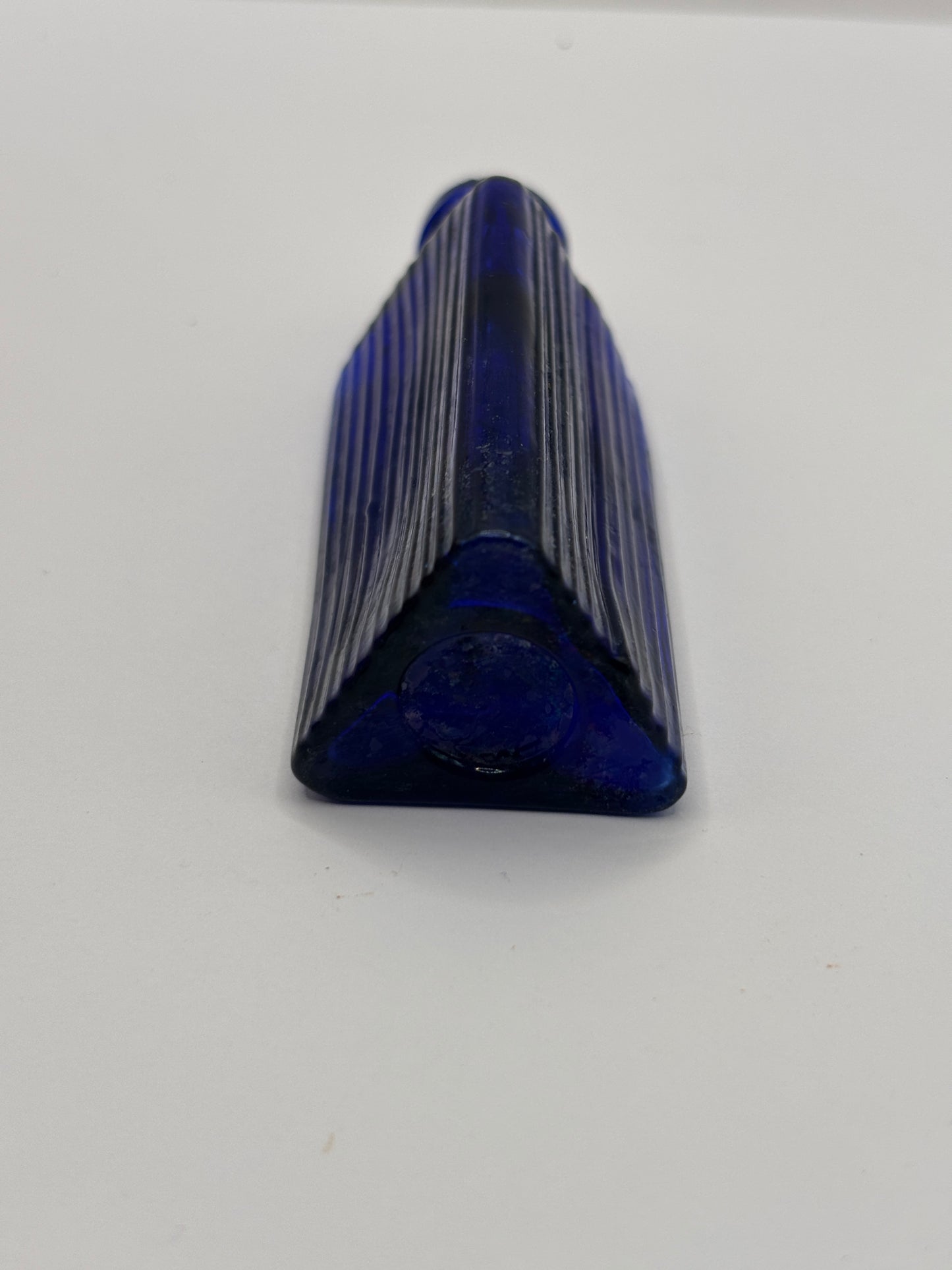 Old small blue triangular poison bottle
