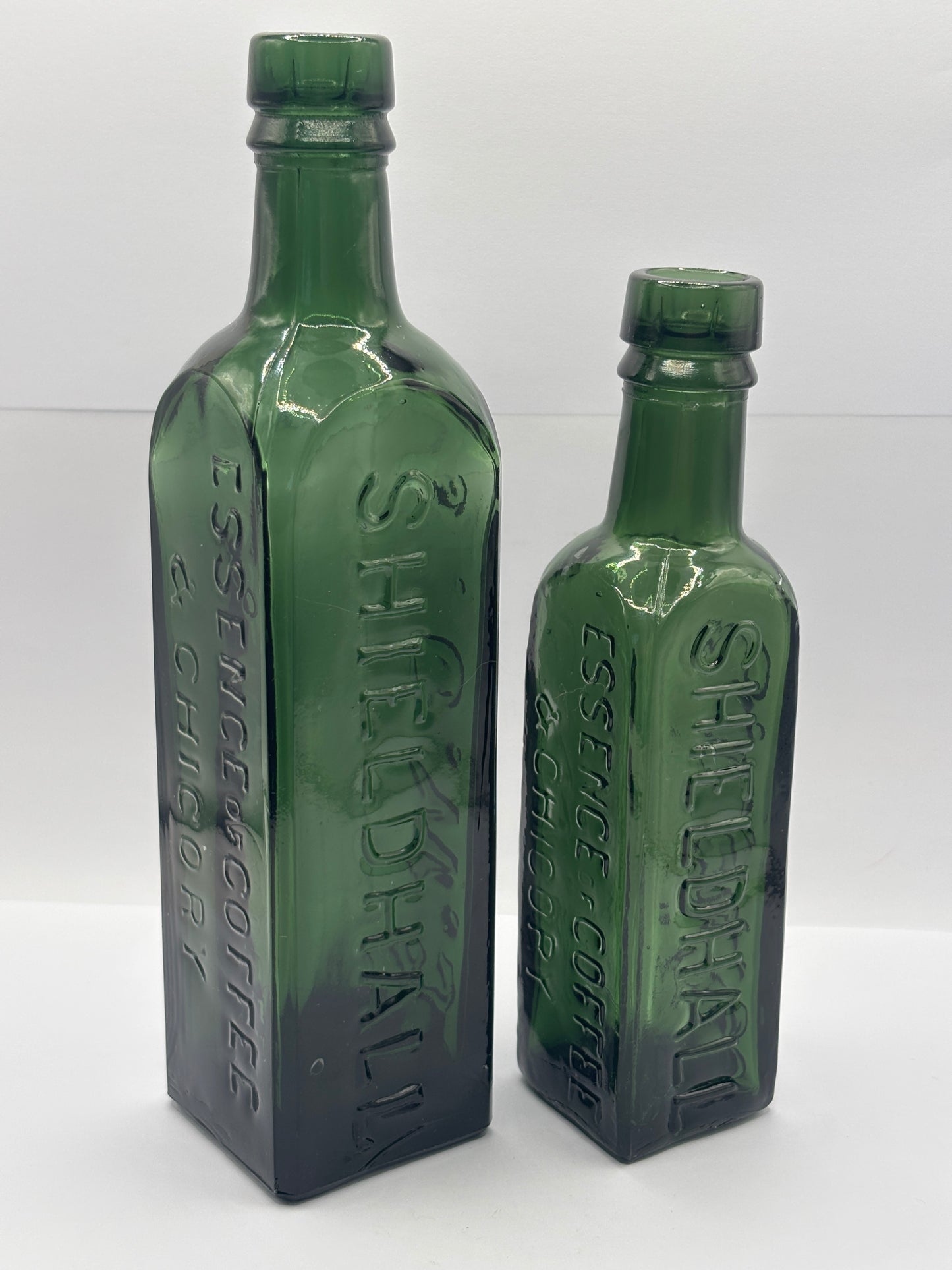 2 old dark green essence of coffee and chicory bottles