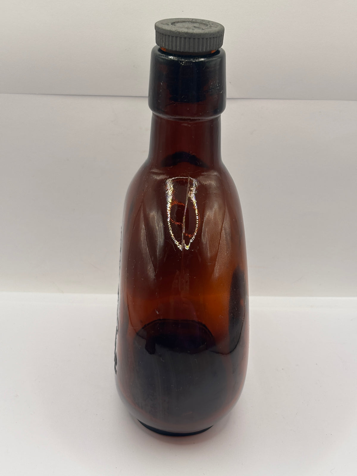 Old amber glass bottle with original stopper