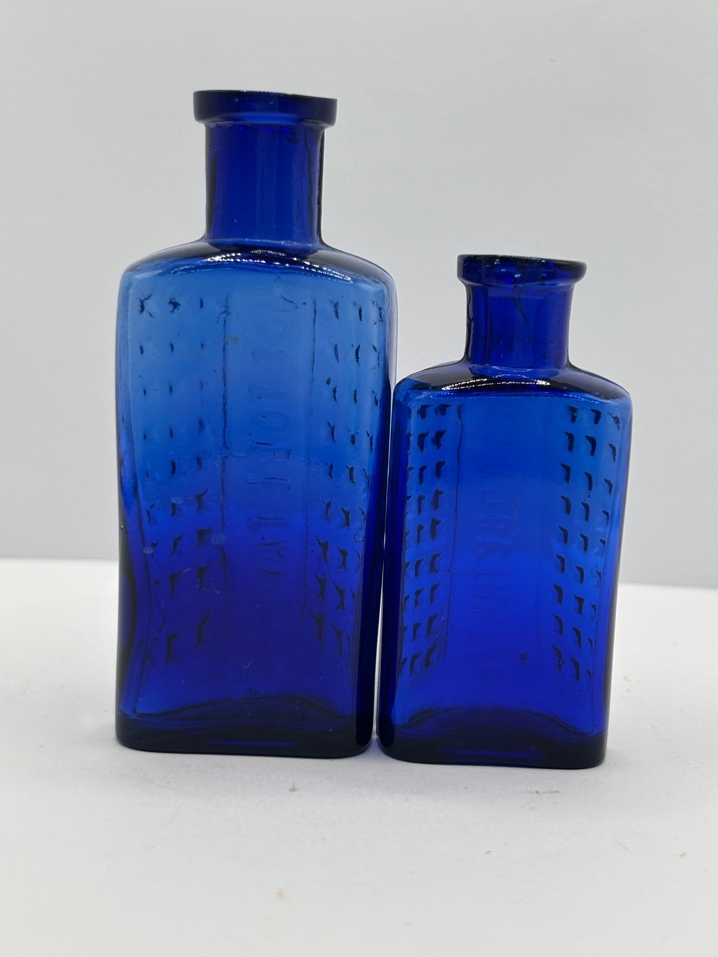 2 old blue flat back poison bottles