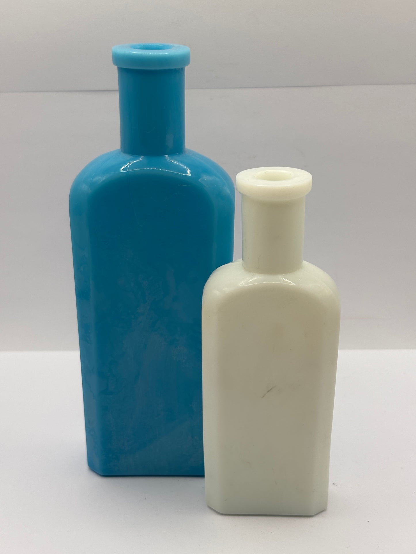 2 old milk glass bottles