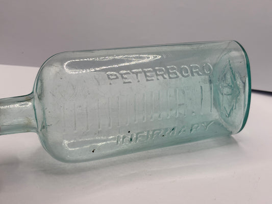 Old aqua glass peterboro infirmary chemist bottle. Peterborough