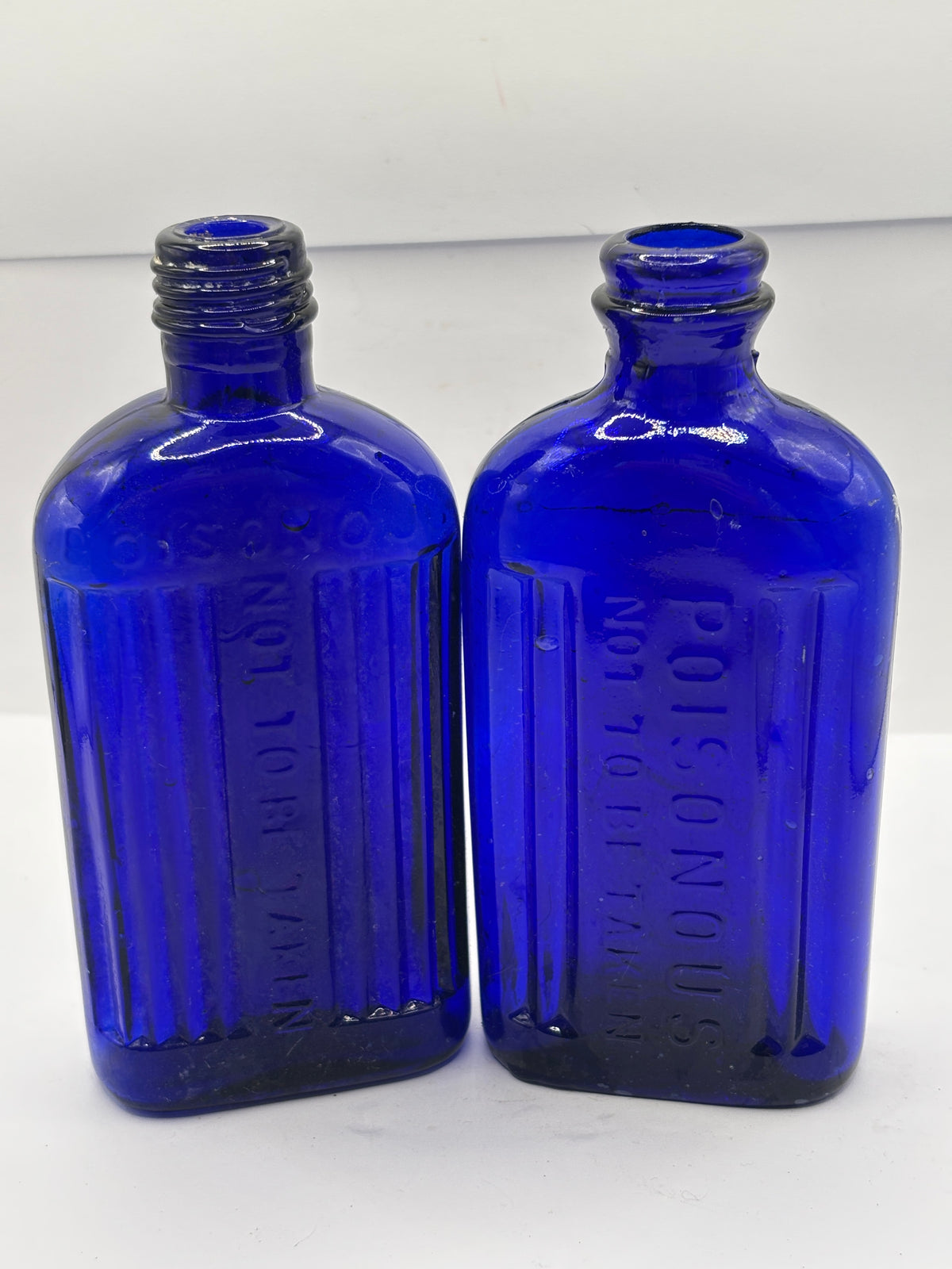 2 old blue glass ribbed poison bottes, not to be taken