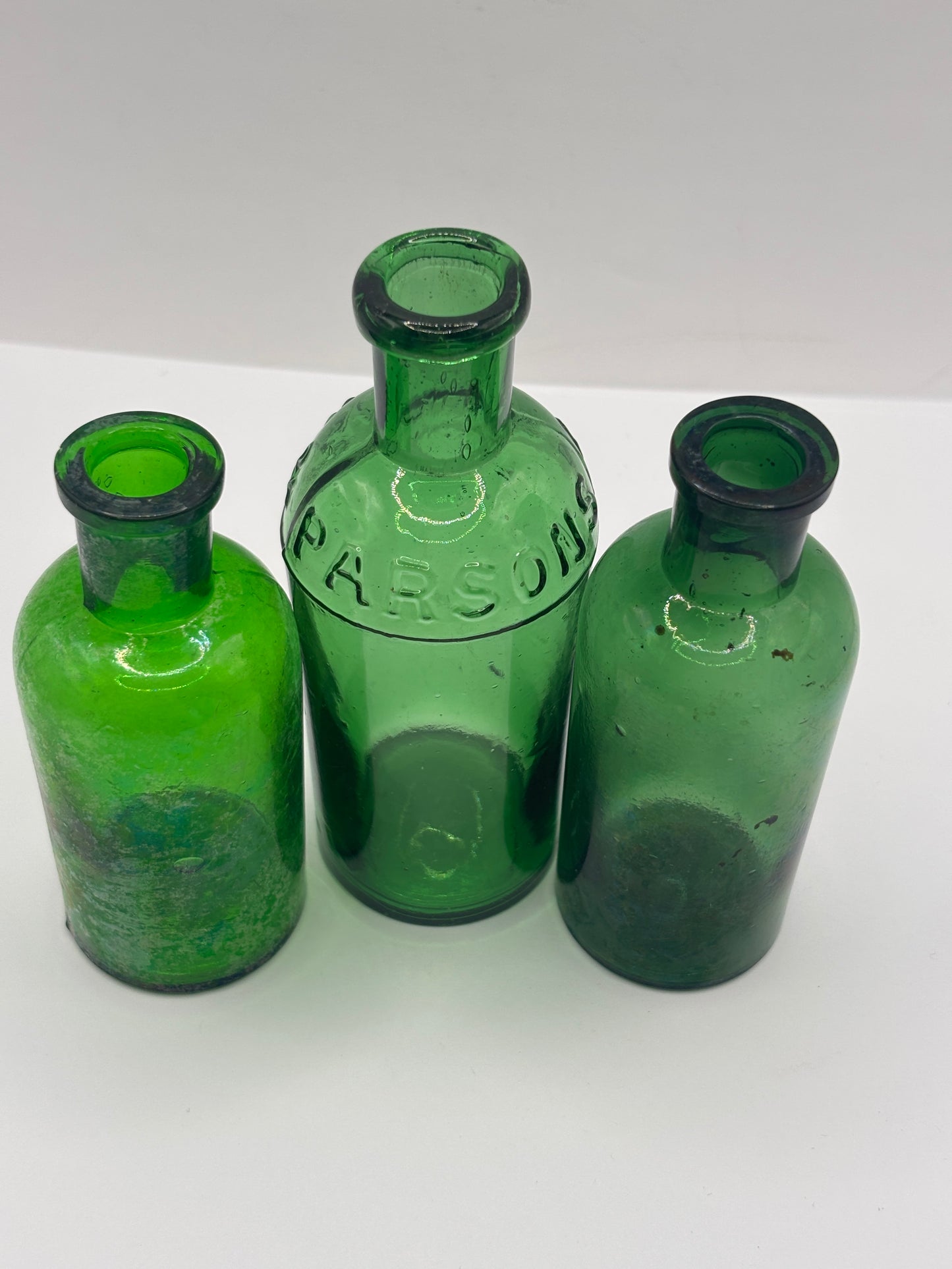 3 old green glass bottles