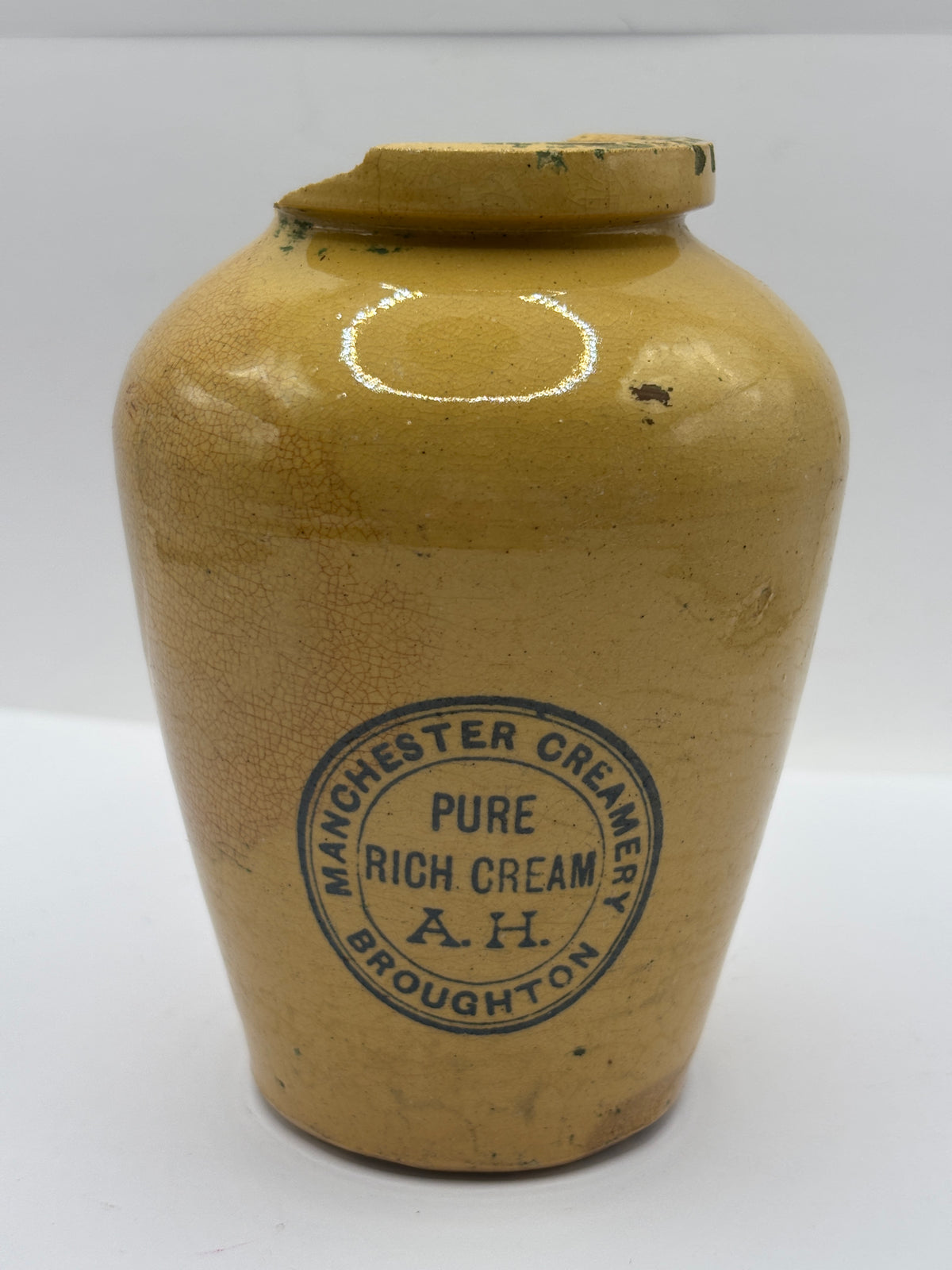Old advertising cream pot,  Manchester creamery. Damaged