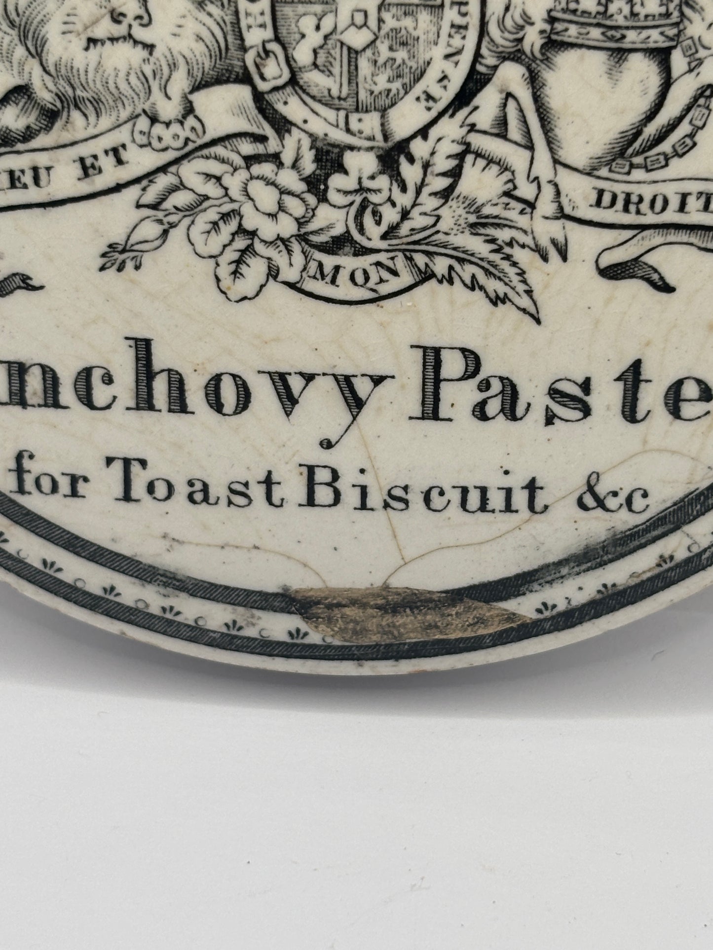 Old early advertising lid, large Burgess anchovy paste. Repaired