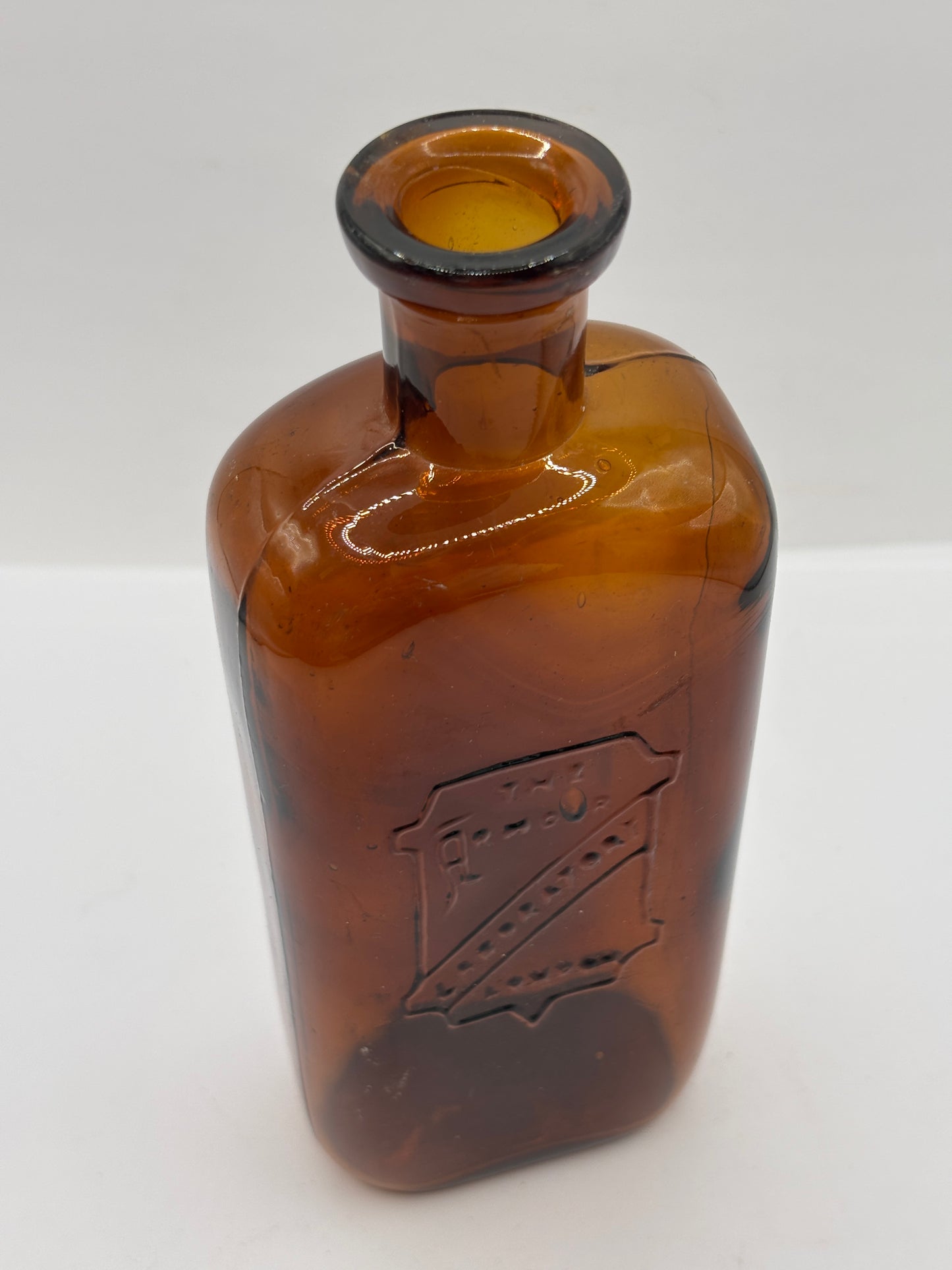 Old amber glass chemist bottle