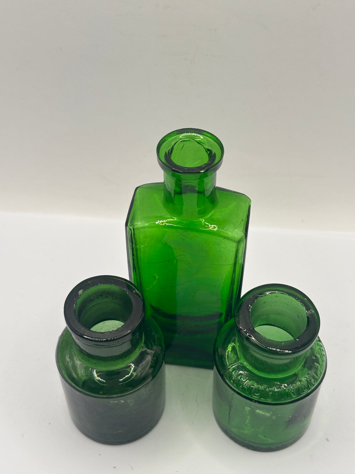 3 small old green bottles