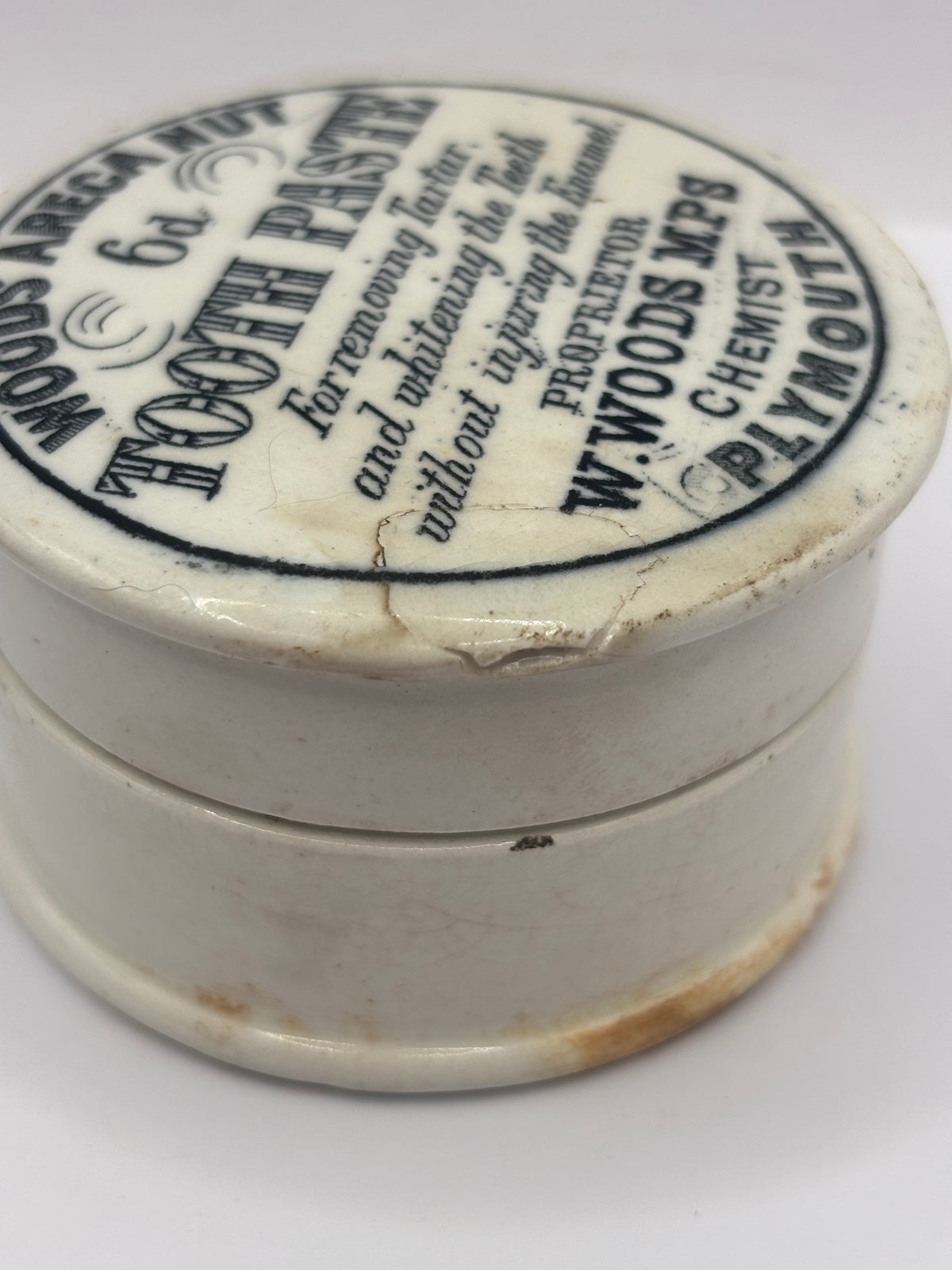 Old advertising lid and base. Woods areca nut tooth paste. Damaged