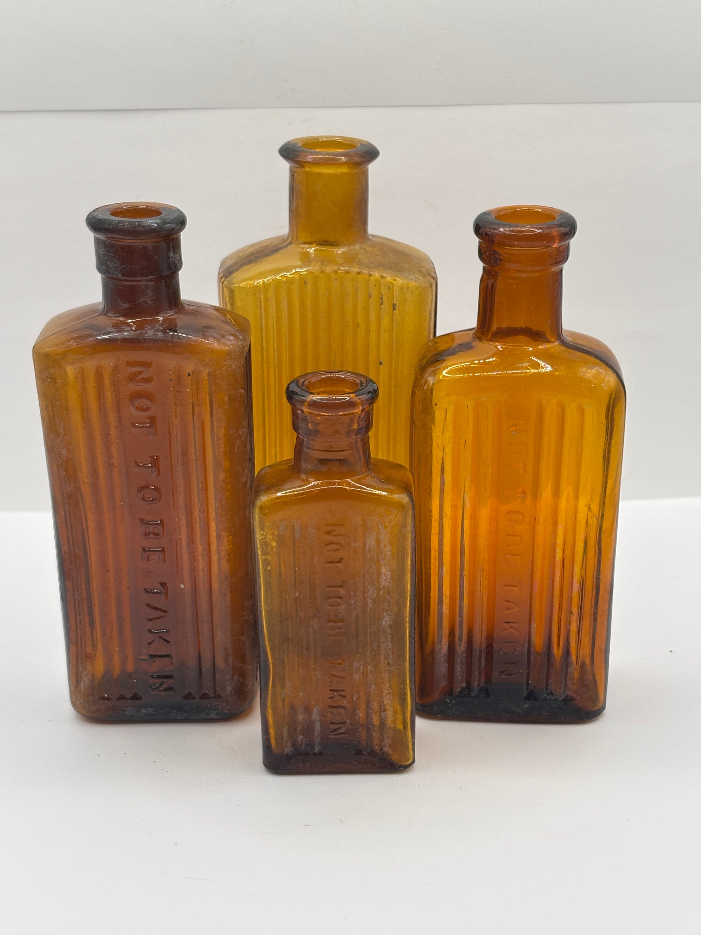 4 crusty Old amber glass poison bottles