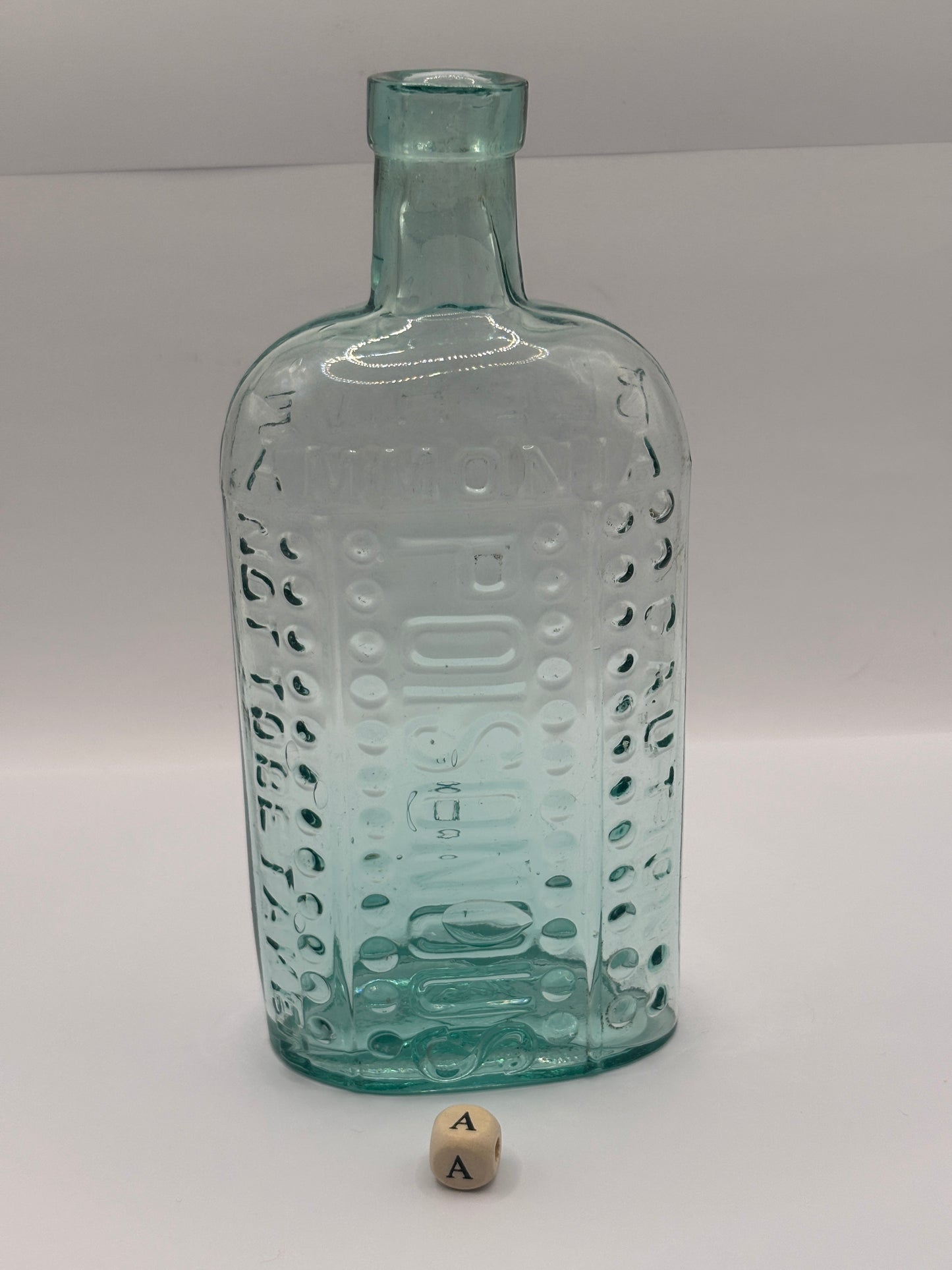 Old aqua glass poison bottle, (a) ammonia, poisonous