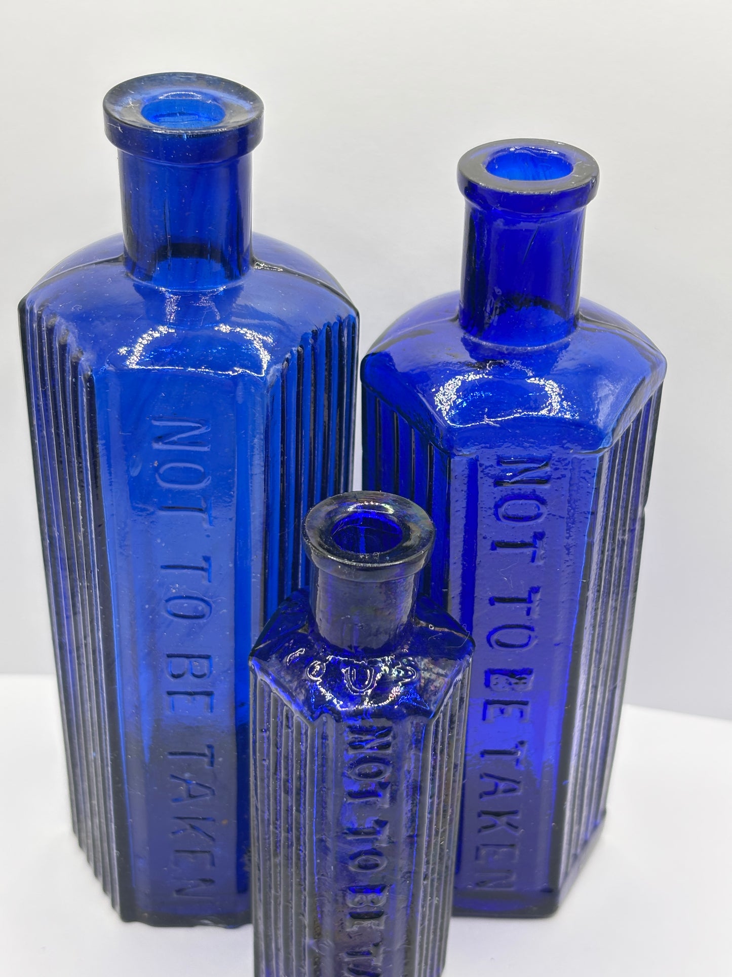 3 old blue poison bottles, not to be taken. Poisonous