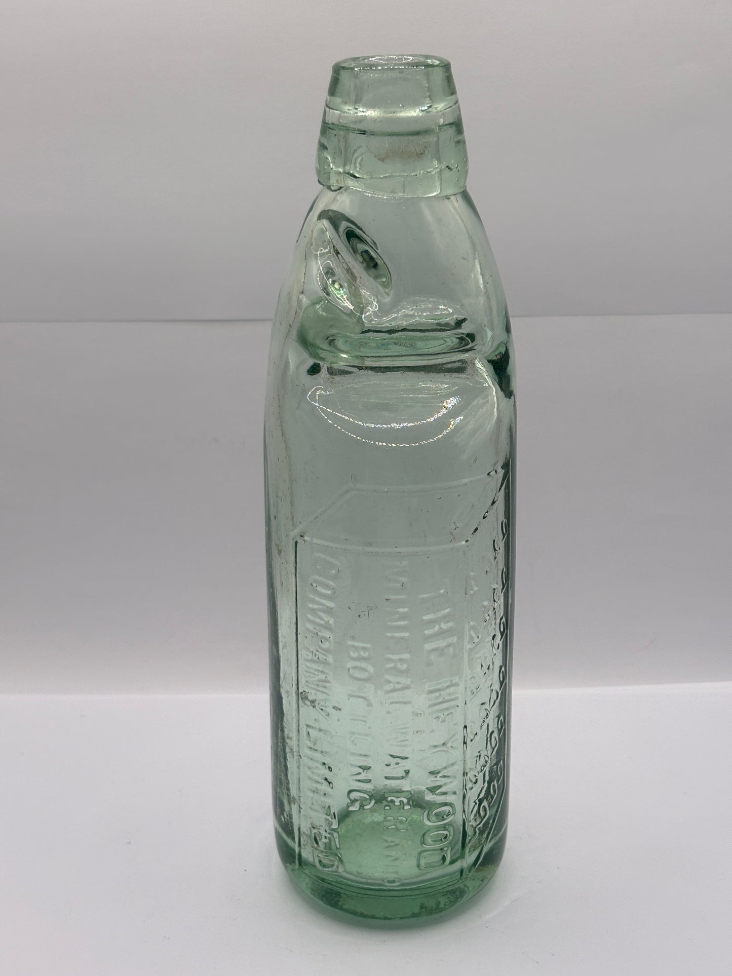 Old glass codd bottle, with marble. The Heywood mineral water bottling co