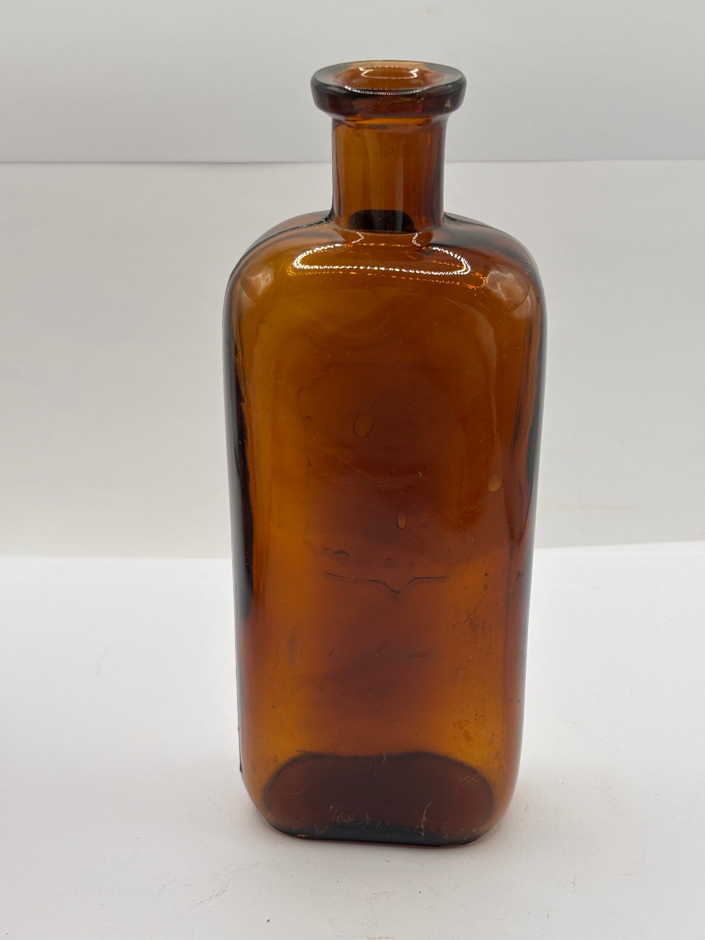 Old amber glass chemist bottle