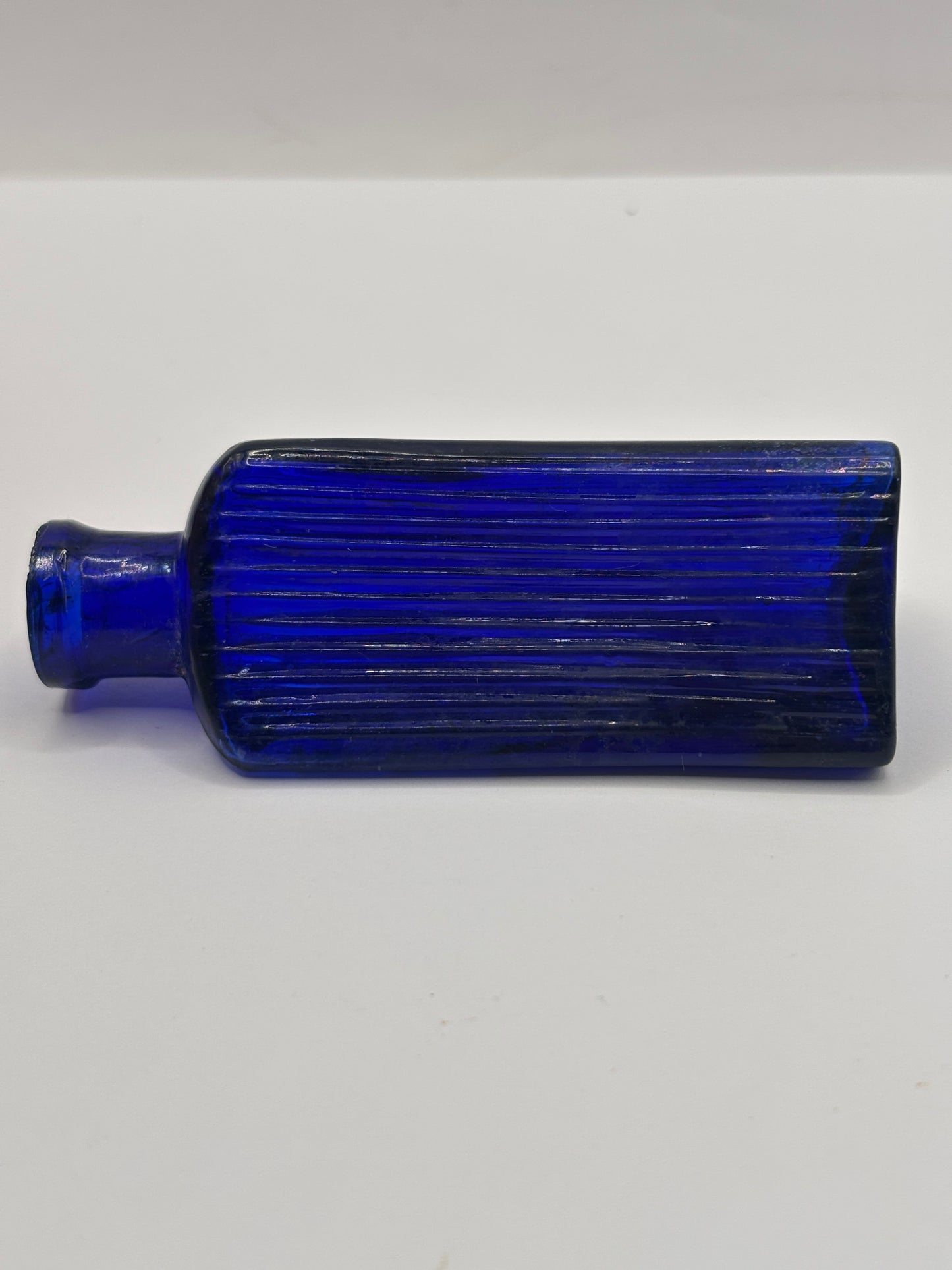 Old small blue triangular poison bottle