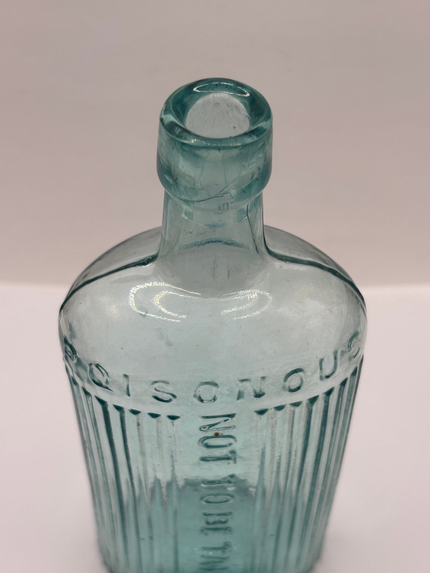 Old aqua glass poison bottle, not to be taken