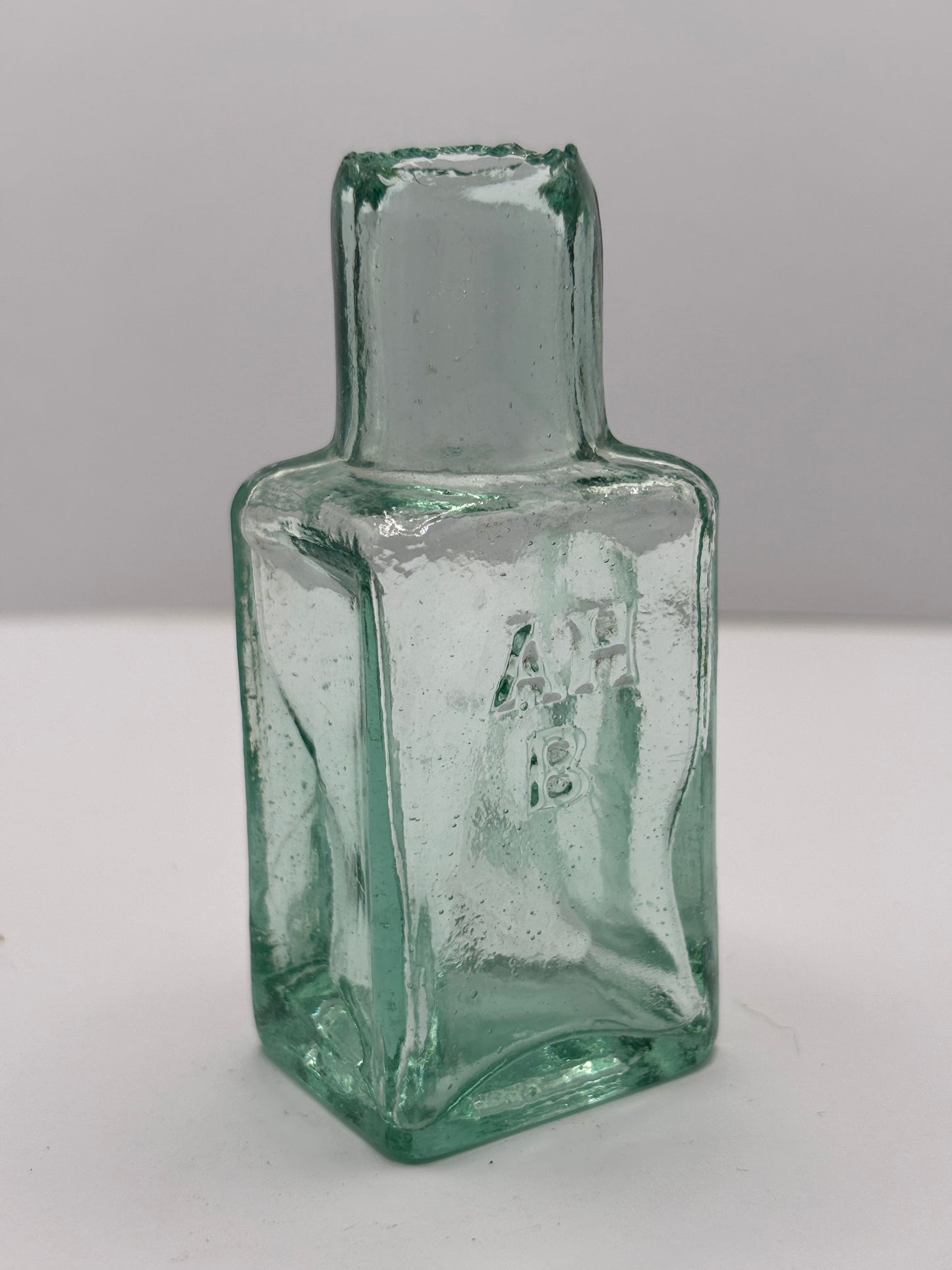 Old aqua glass advertising ink & gum bottle, inkwell. AHB