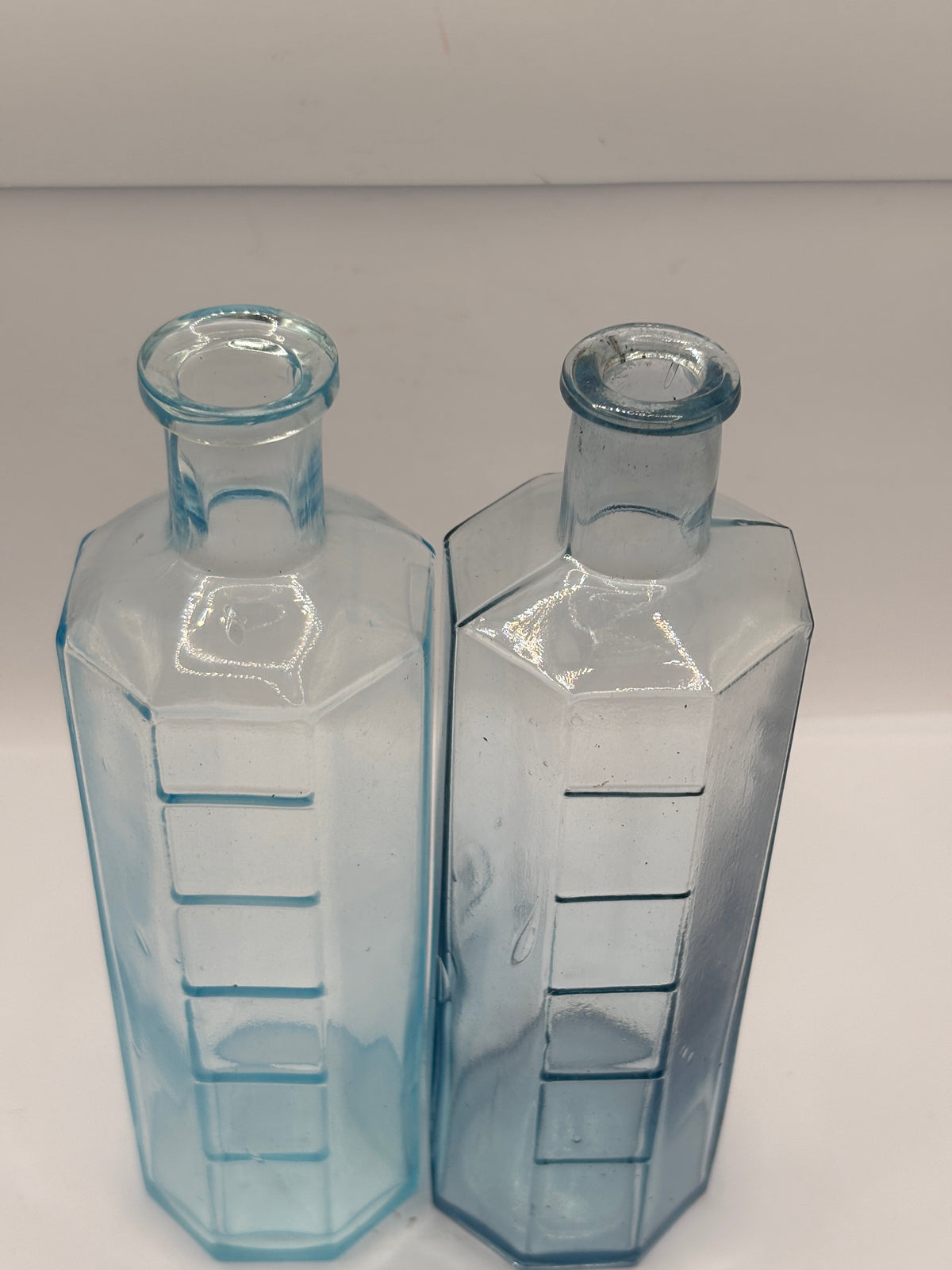 2 old glass medicine bottles