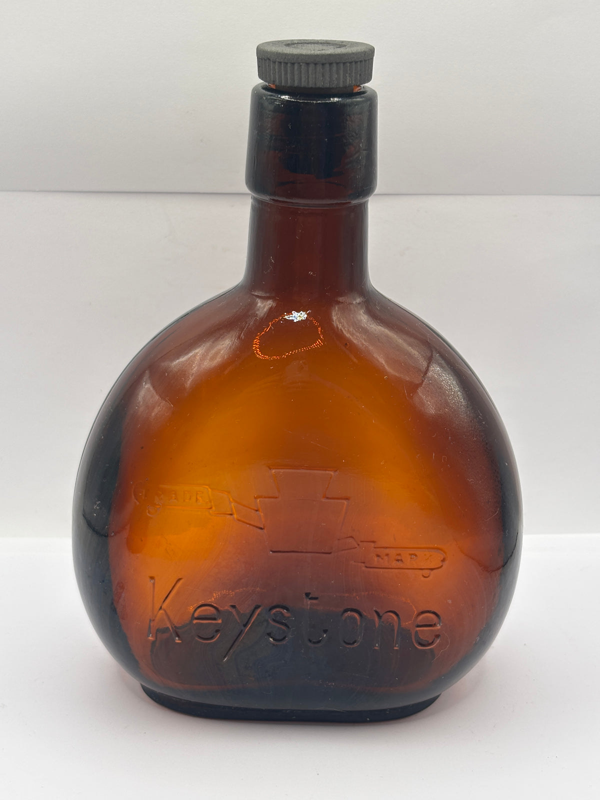 Old amber glass bottle with original stopper
