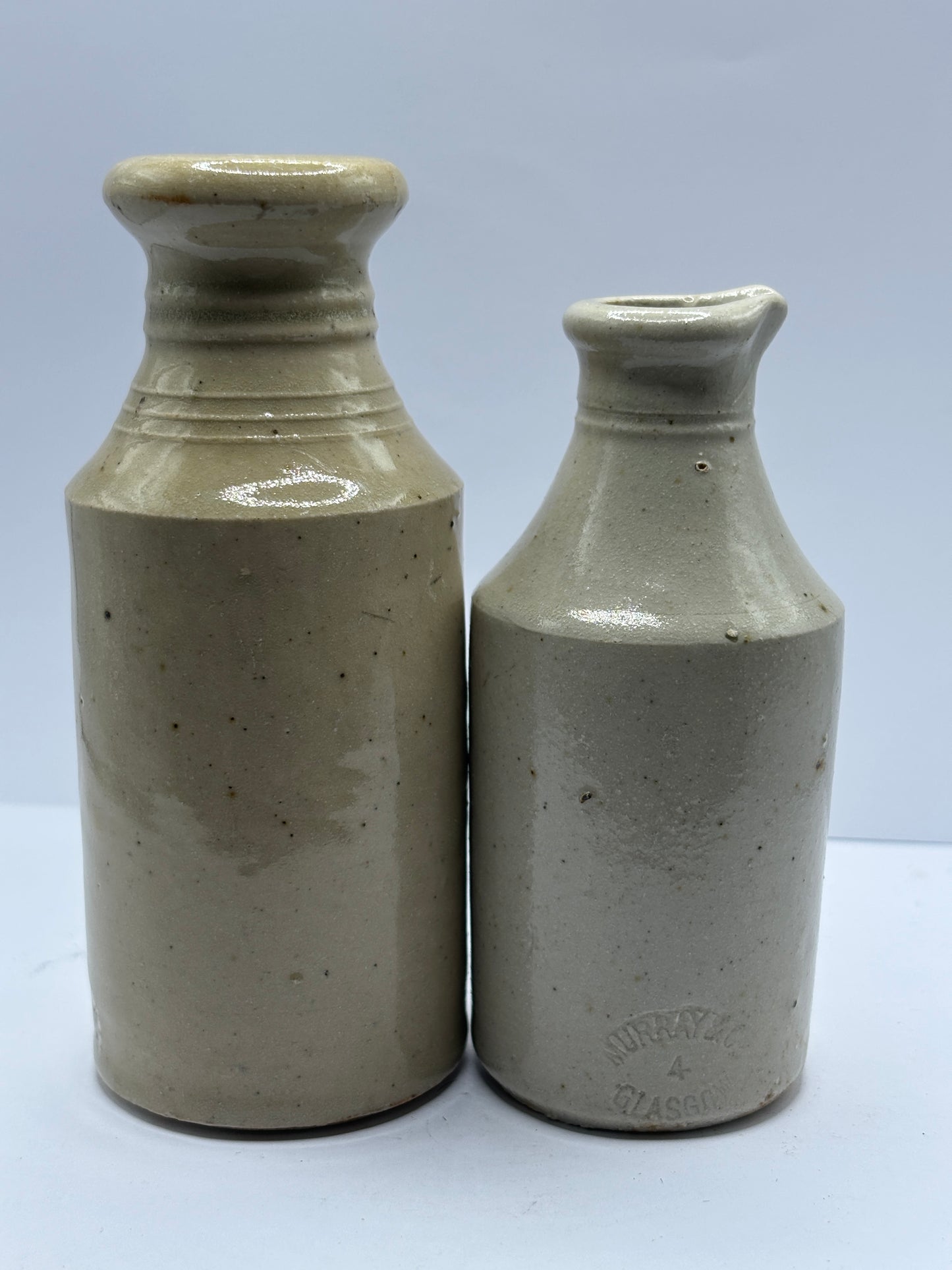 2 old white stoneware bottles