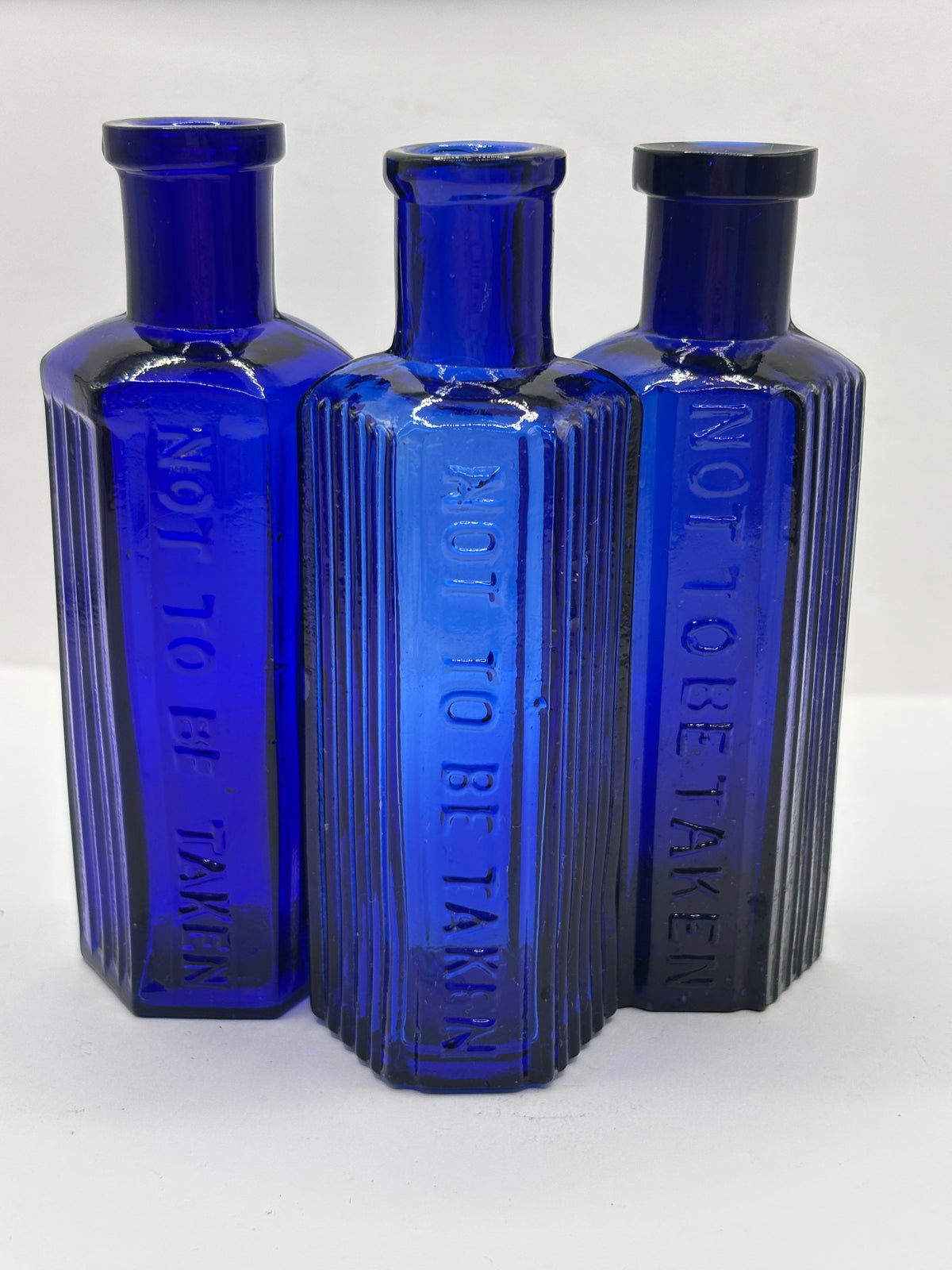 3 old small blue ribbed poison bottles, not to be taken