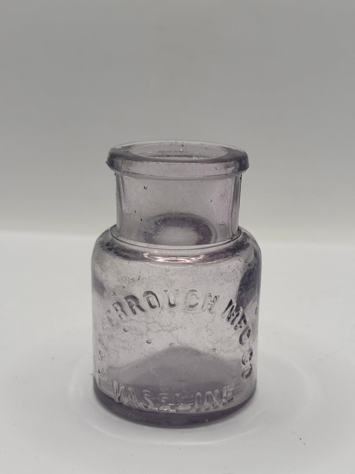 Old crusty purple glass vaseline jar