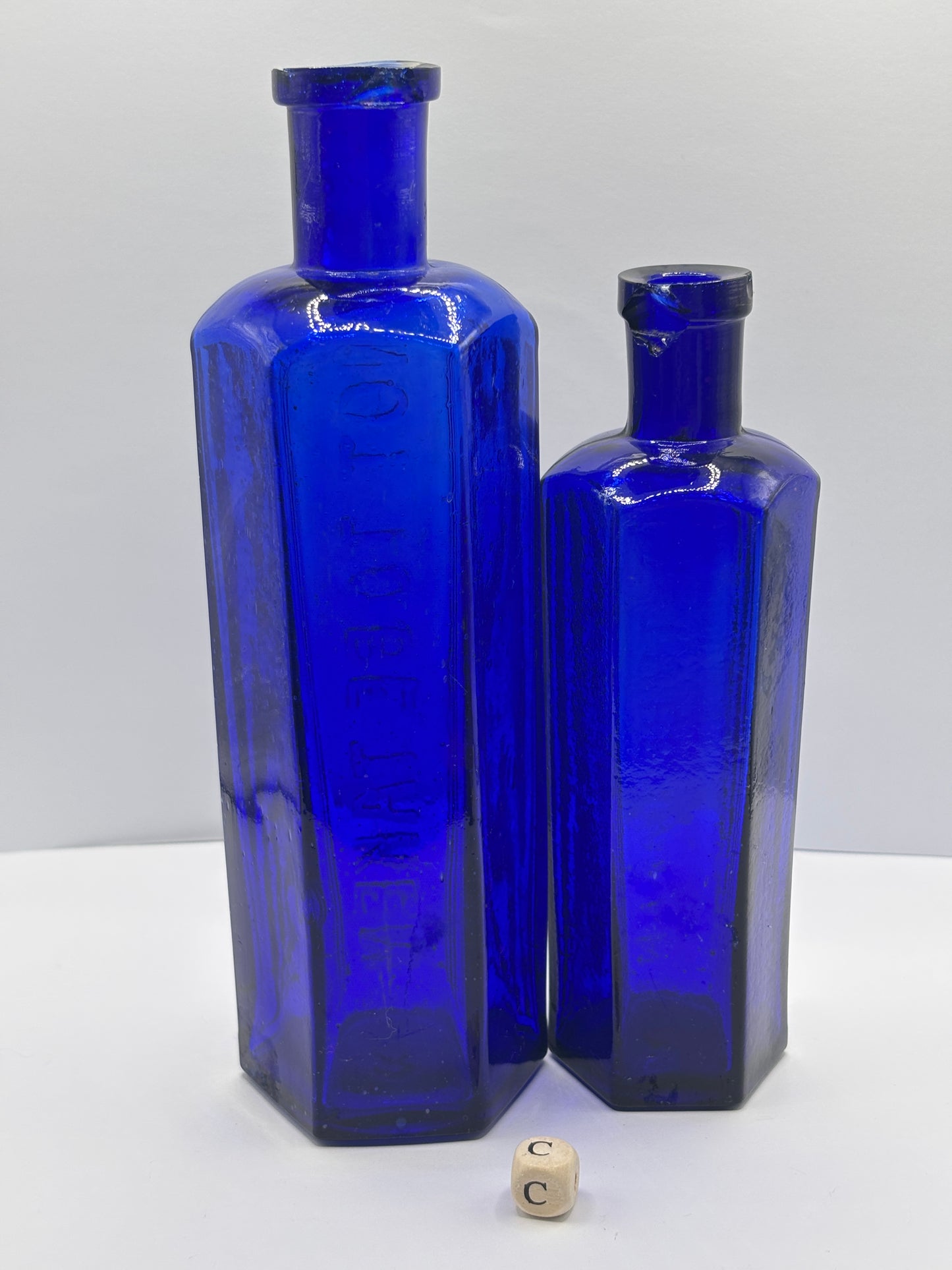 2 Old blue glass ribbed poison bottles. ‘not to be taken’ (C) damaged