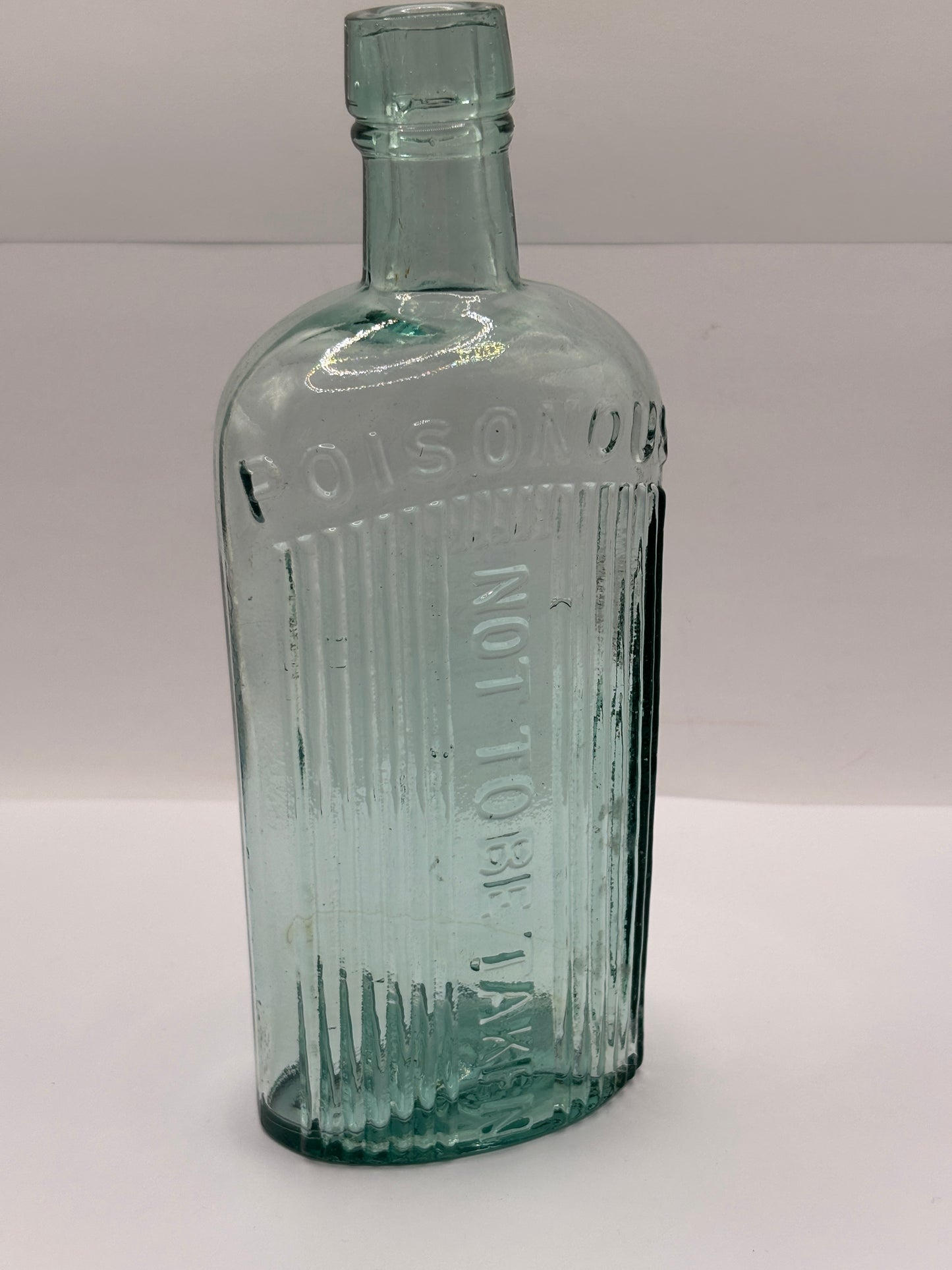 Old aqua glass poison bottle, Poisonous not to be taken