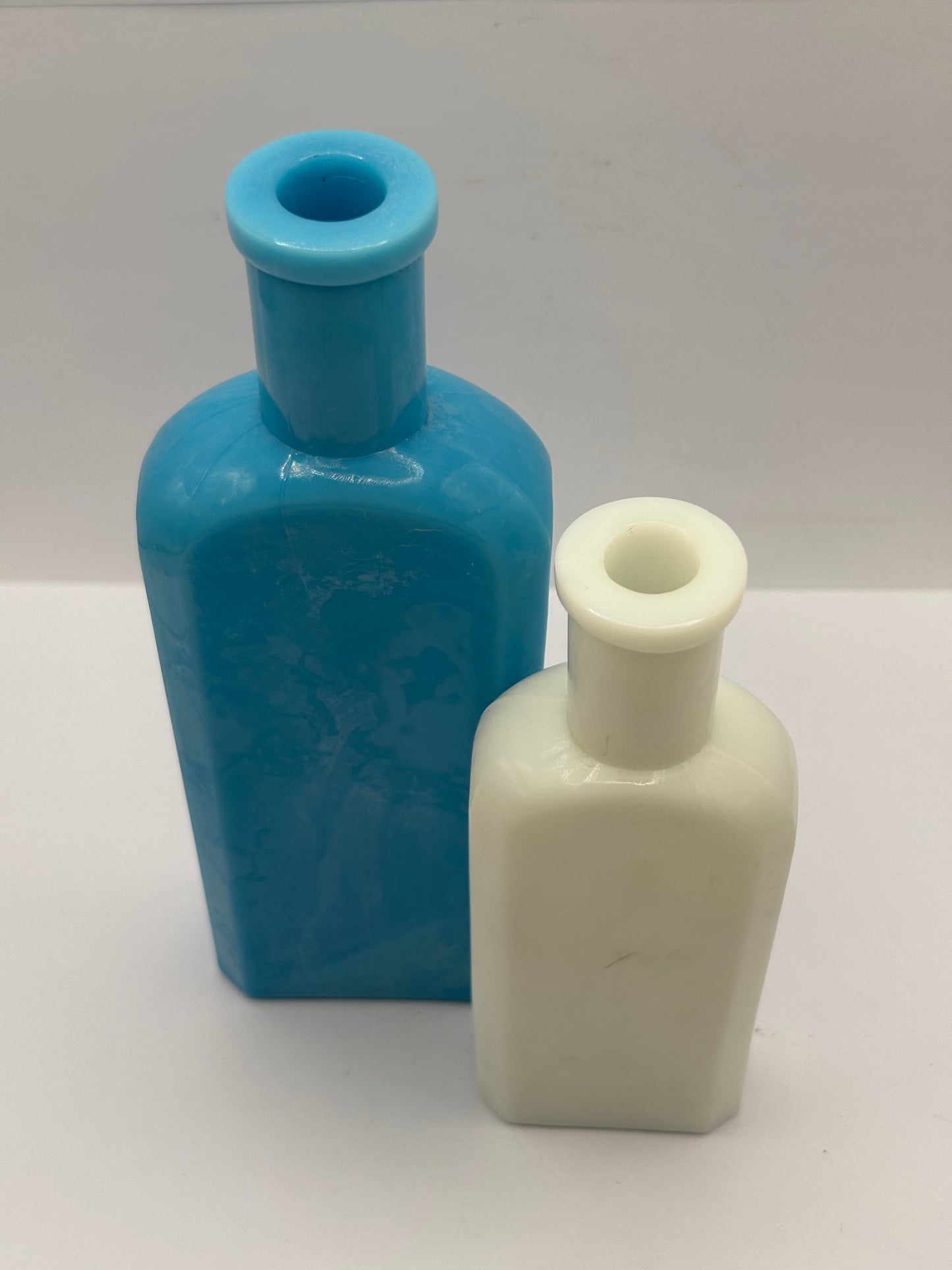 2 old milk glass bottles